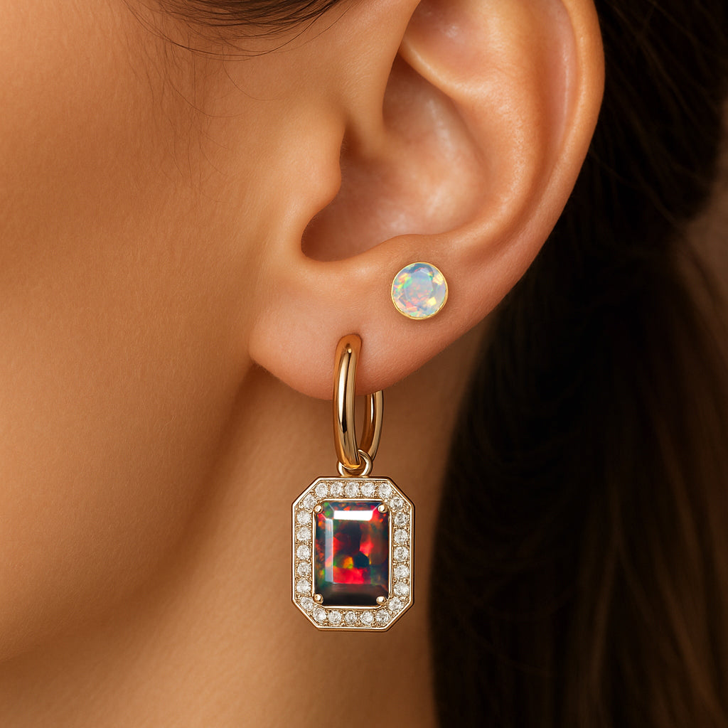 Woman wearing opal stud and rectangular gemstone drop earrings in gold setting