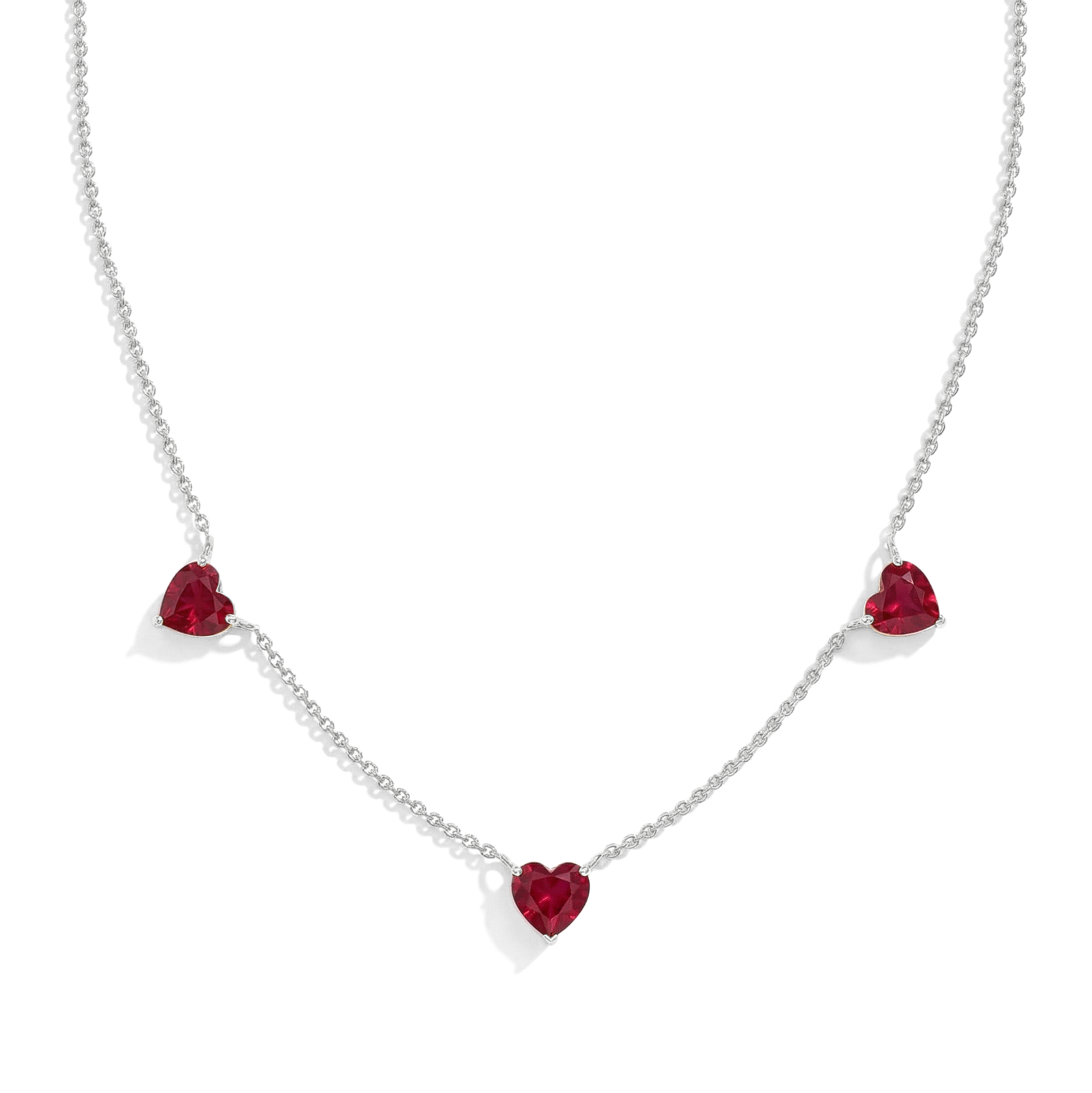 Genuine Ruby Three Stone Heart Necklace handcrafted in sterling silver."