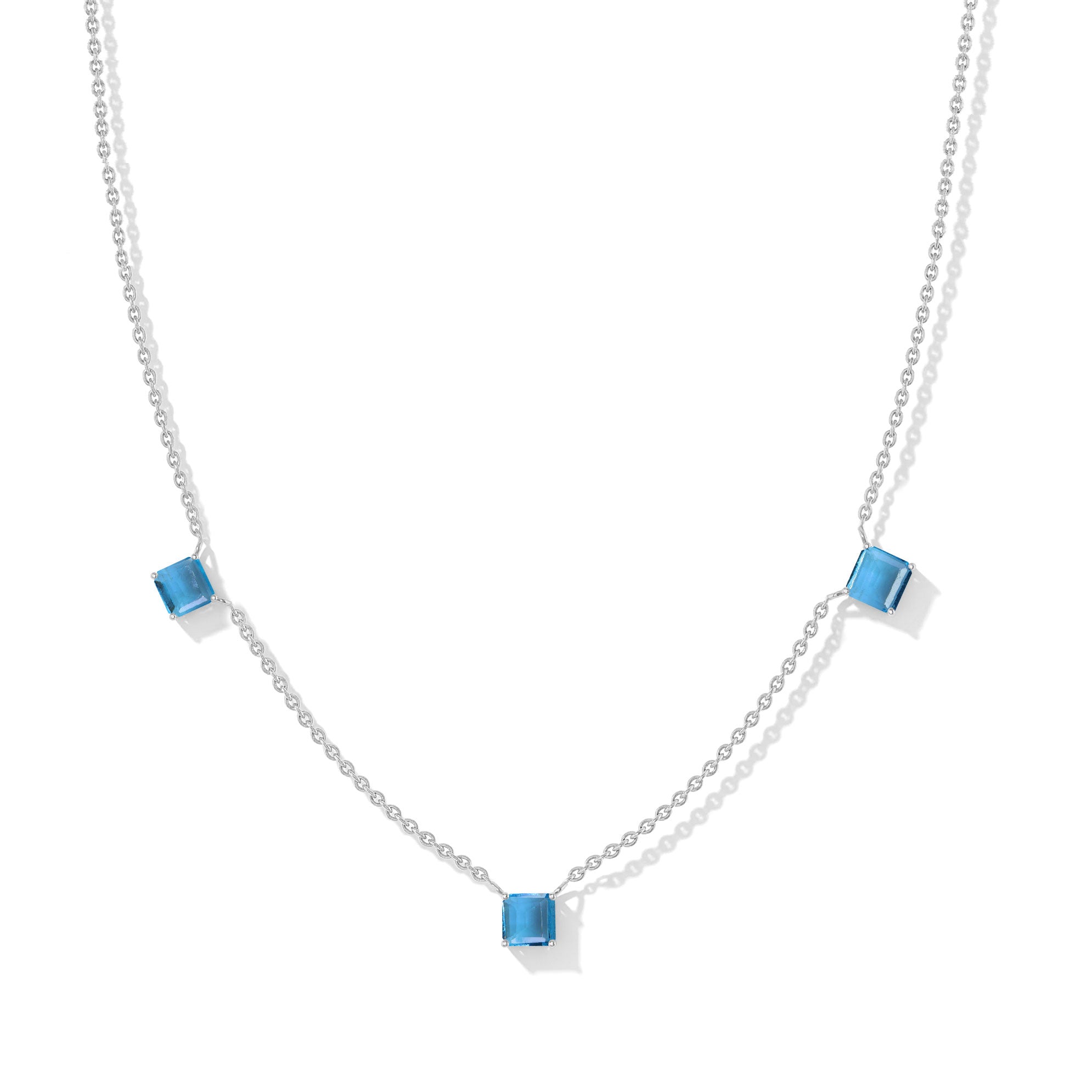 "Elegant Blue Topaz Asscher cut necklace with three sparkling blue gemstones in sterling silver.