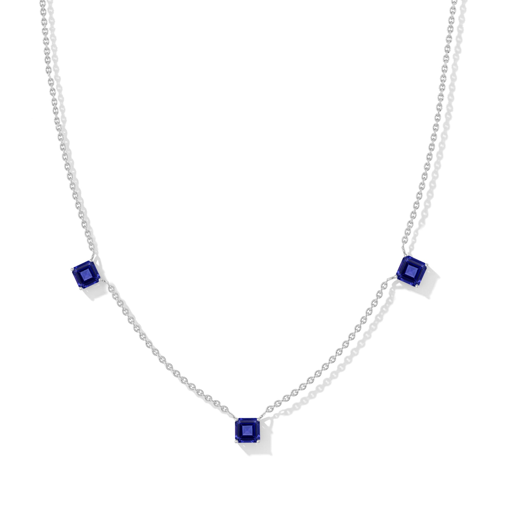 "Tanzanite Asscher cut station necklace in yellow gold filled and 925 sterling silver featuring three gemstones.