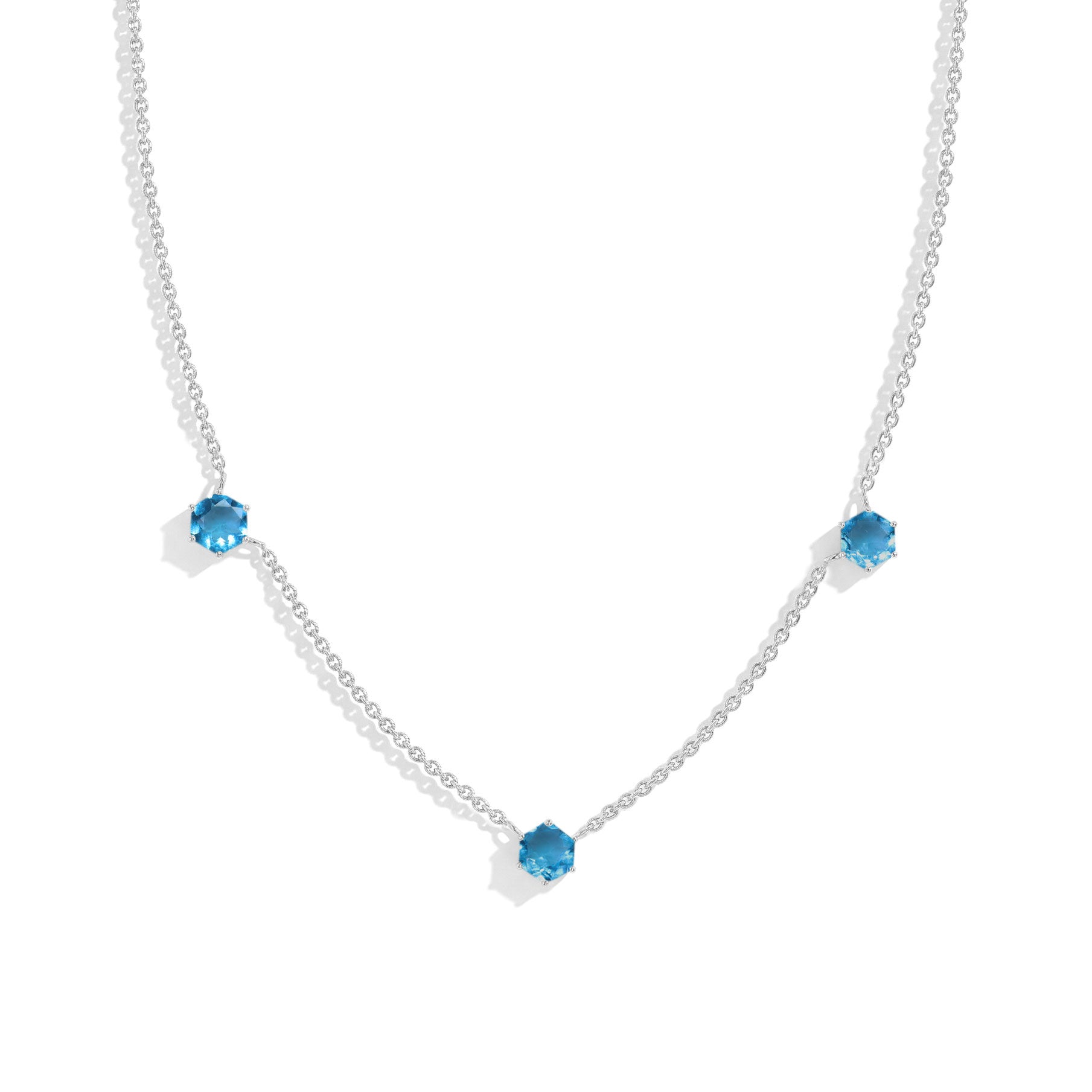 "Three stone blue topaz station necklace featuring hexagon cut gemstones in 925 sterling silver