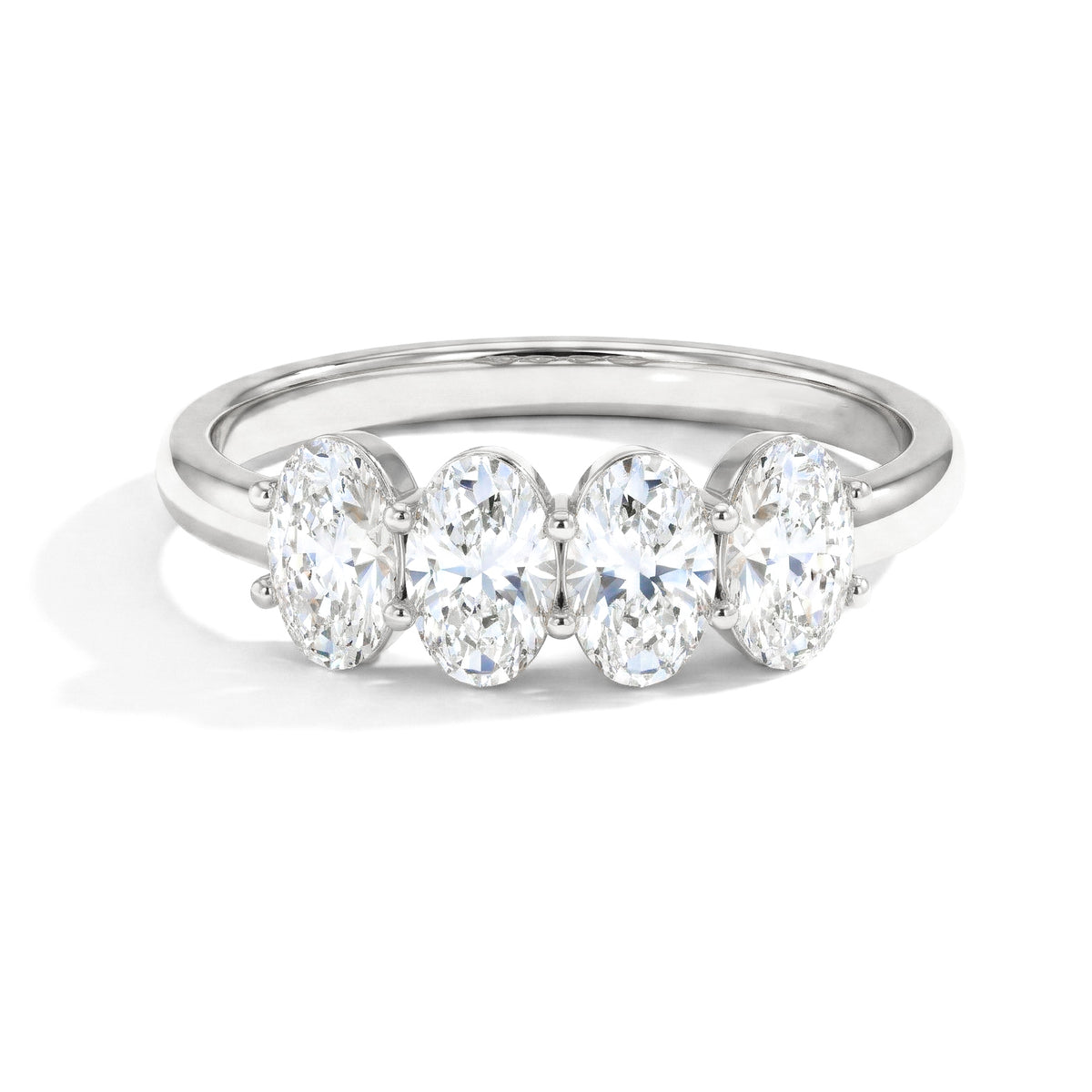 moissanite ring, four stone ring, oval moissanite ring, brilliant gemstone ring, sparkling ring, minimalist jewellery, elegant stacking ring, bridal ring, anniversary gift, women's jewellery, statement ring, luxury jewellery, polished band