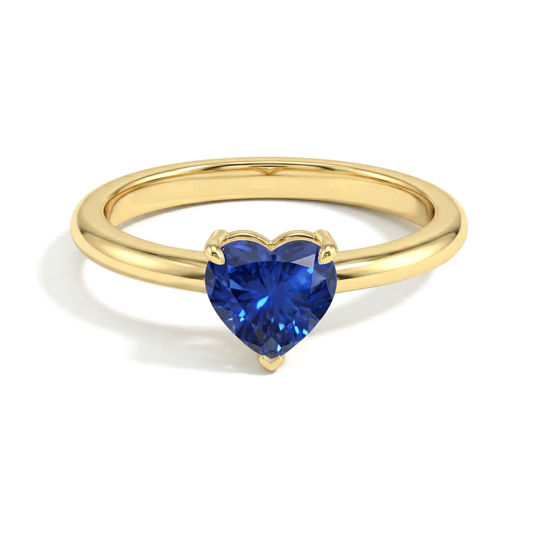 blue sapphire engagement style ring, heart cut jewellery, handcrafted fine ring, sterling silver fashion accessory, yellow gold filled heart jewellery, promise band, elegant sapphire gemstone, women's anniversary jewellery, artisan crafted ring, polished finish accessory, september birthstone ring, luxury handmade jewellery, minimalist solitaire, timeless elegance, romantic gift