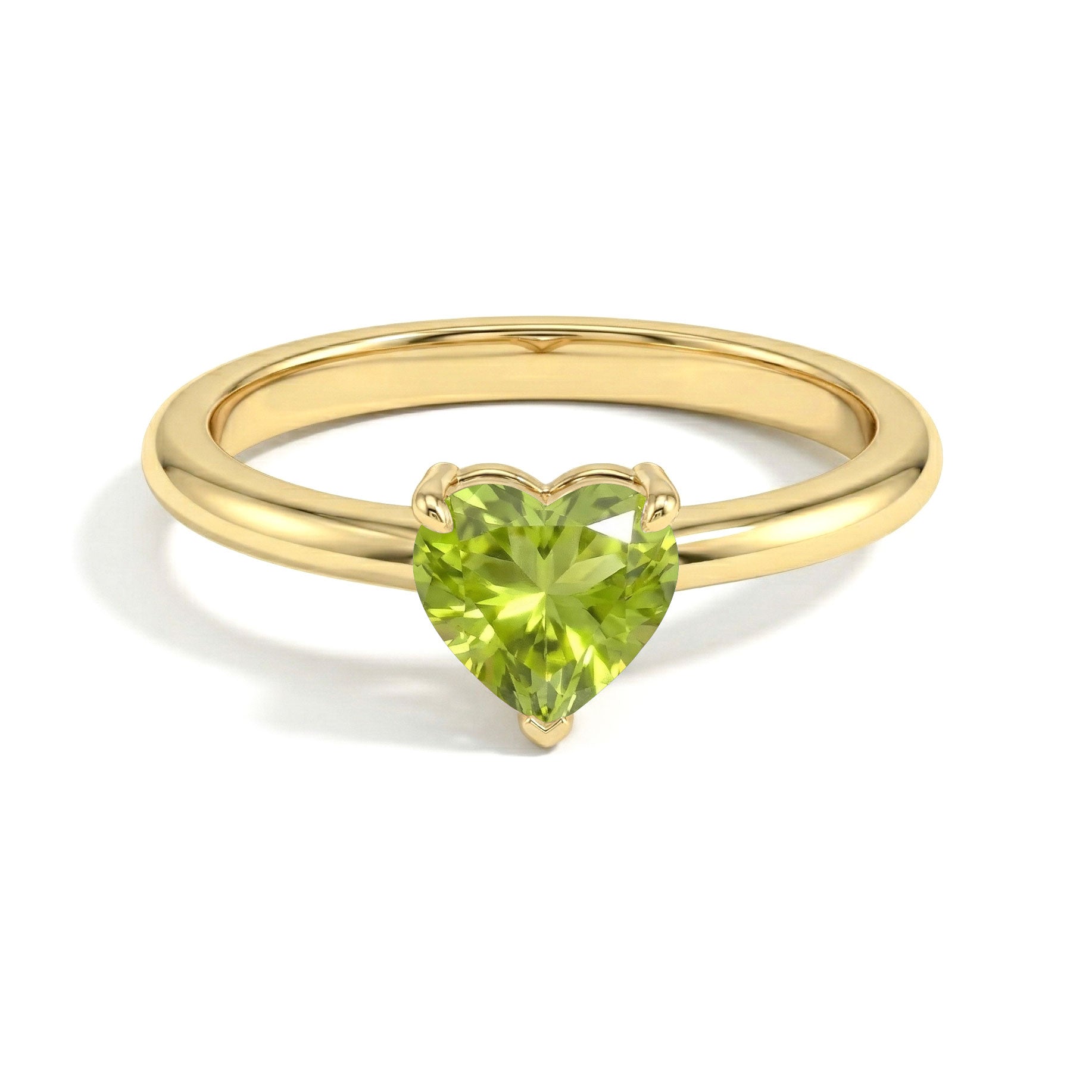 natural peridot fine jewelry, heart gemstone solitaire ring, elegant green birthstone, polished comfort ring, refined women's accessory, minimalist engagement jewelry, stackable gemstone ring, classic jewelry design, everyday luxury piece, feminine heart ring, stylish jewelry