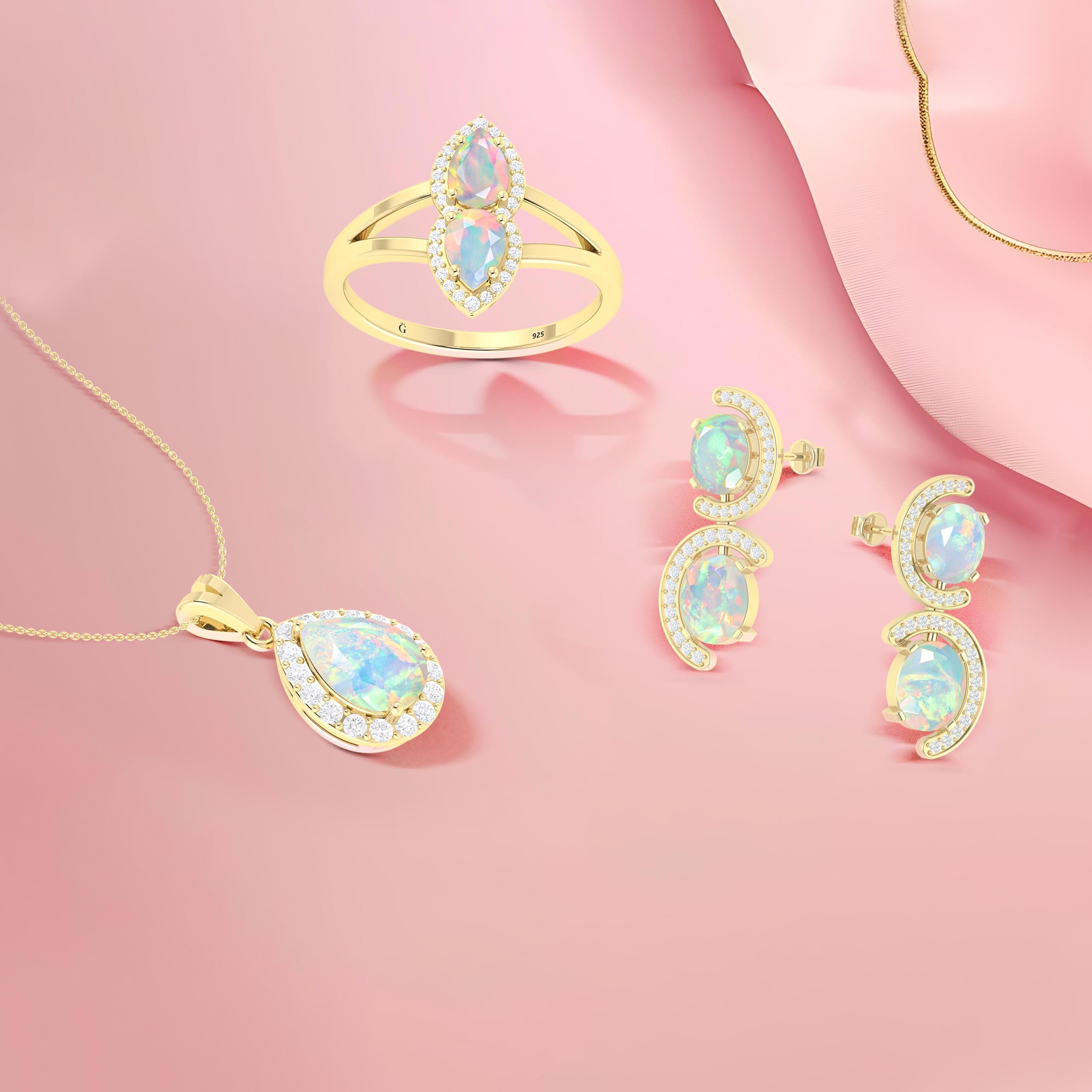 White opal jewelry set with gold ring, pendant necklace, and earrings on a soft pink background.