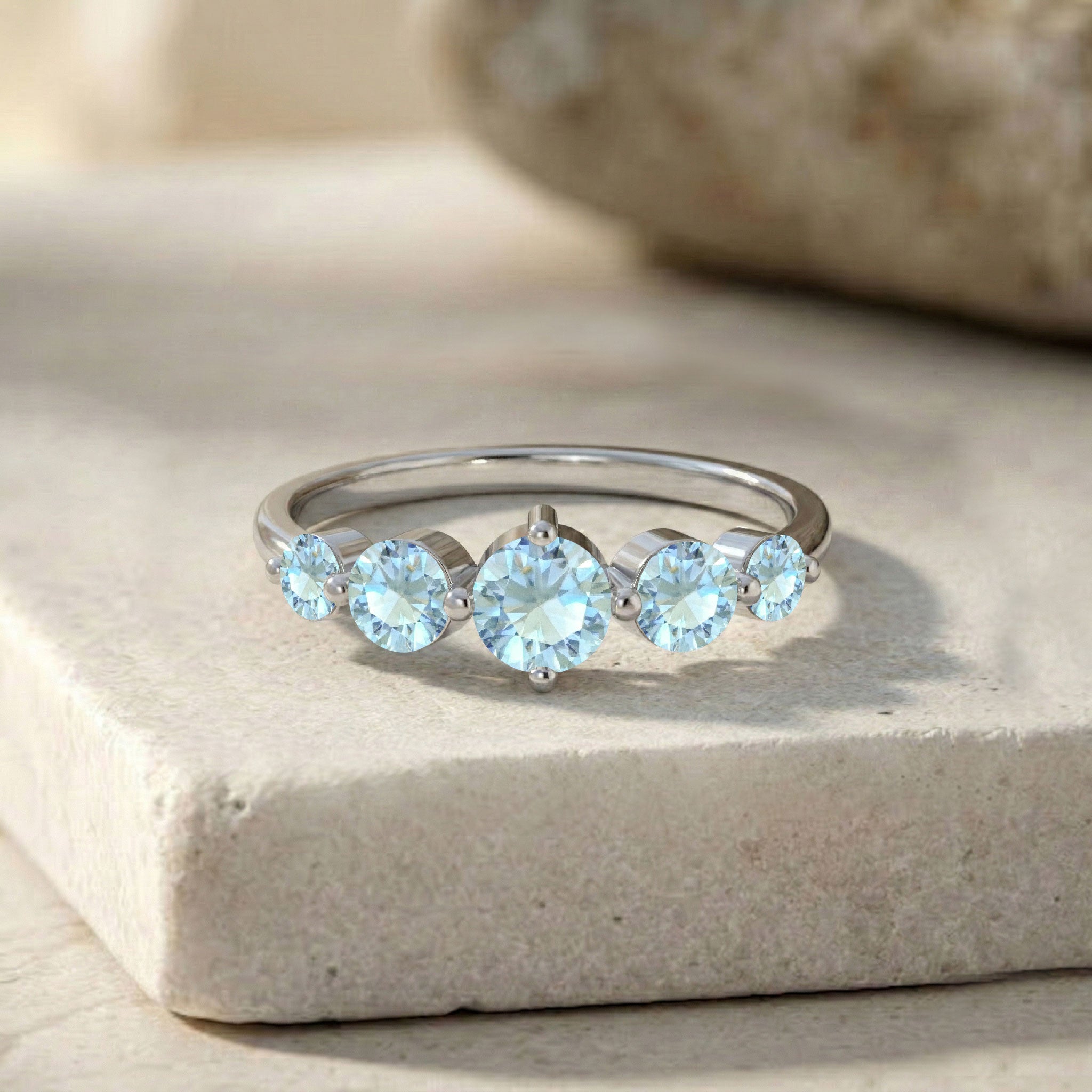 five stone aquamarine jewelry, polished sterling silver band, handcrafted gold filled ring, round blue gemstone setting, elegant birthstone jewelry, sparkling gemstone brilliance, women's anniversary gift, artisan jewelry craftsmanship, premium ring design, sophisticated accessory, classic fashion jewelry, stacking ring inspiration, refined gemstone style, timeless elegance, comfortable fit