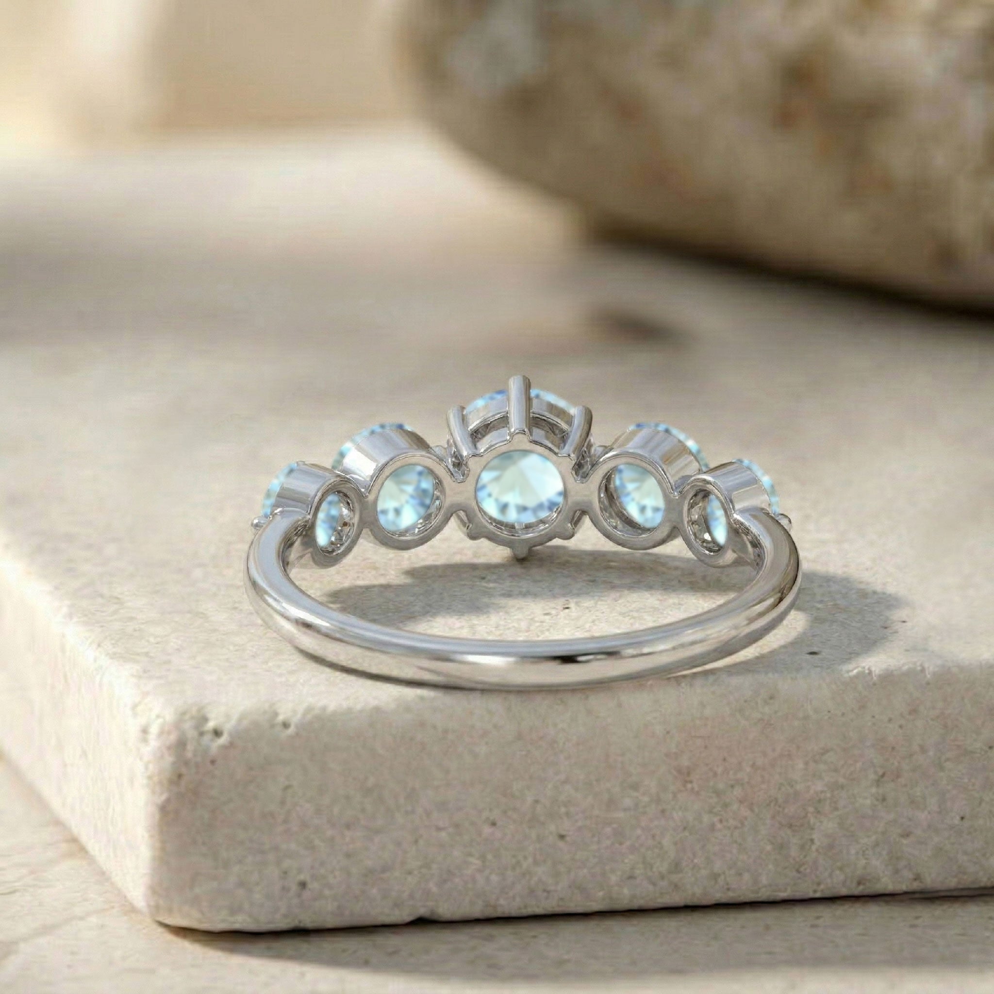 five stone blue gemstone ring, handcrafted premium jewelry, sterling silver fashion accessory, yellow gold filled ring design, polished artisan craftsmanship, elegant ocean inspired jewelry, sparkling round gemstones, women's luxury band, refined anniversary ring, stackable jewelry style, sophisticated gemstone elegance, timeless gift jewelry, comfortable fit band, classic handcrafted accessory, modern elegance