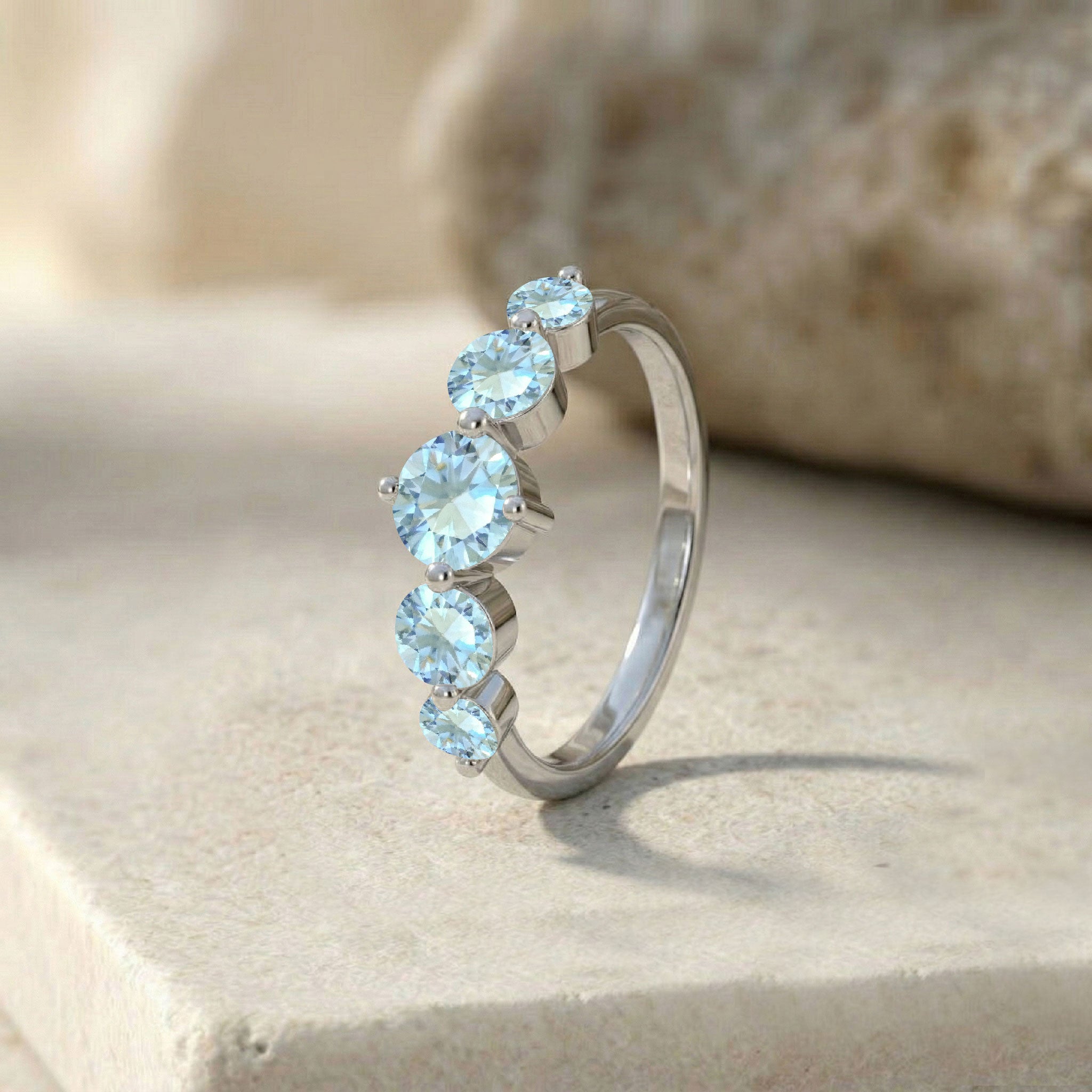 aquamarine statement ring, five stone handcrafted jewelry, sterling silver polished finish, premium gold filled jewelry, brilliant round gemstone band, artisan luxury craftsmanship, feminine fashion accessory, sparkling blue gemstone shine, anniversary keepsake jewelry, refined stacking ring, elegant everyday design, classic gemstone elegance, comfortable fit jewelry, timeless ring style, designer accessory