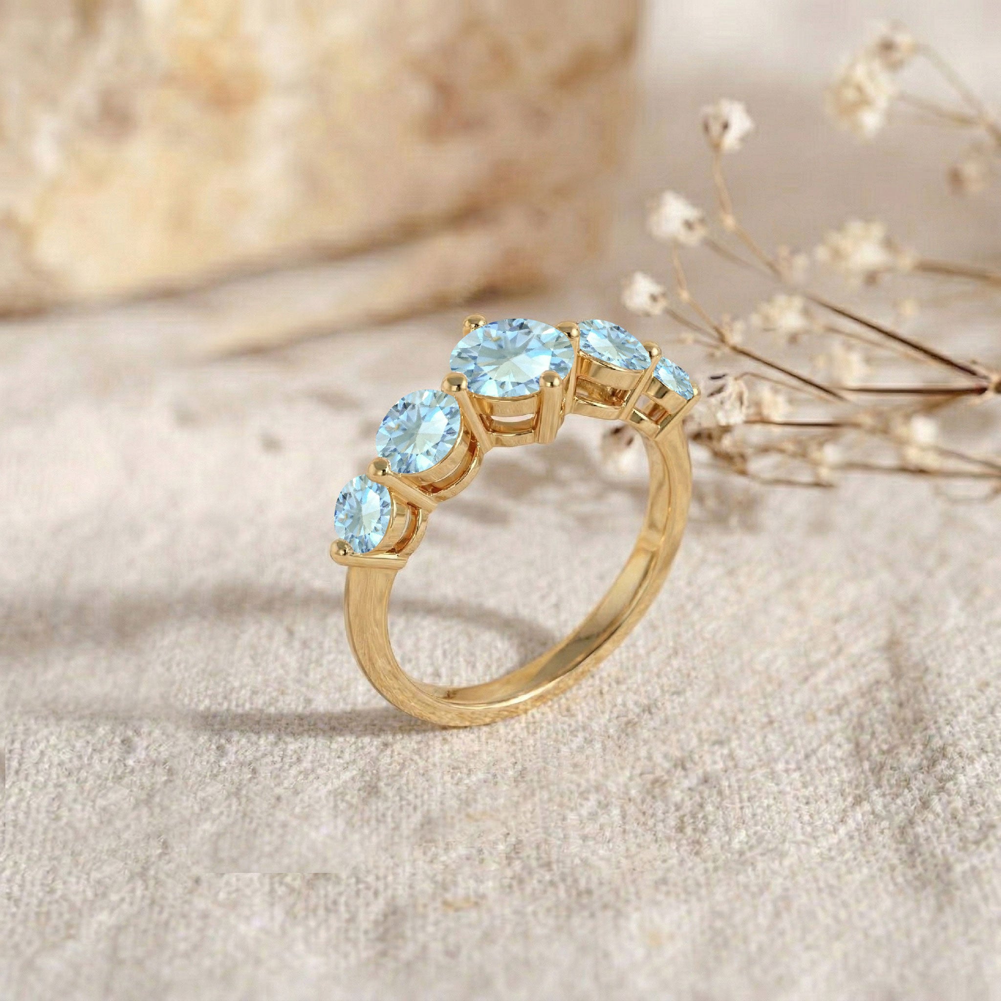 luxury aquamarine ring, graduated gemstone band, handcrafted artisan jewelry, polished sterling silver option, elegant gold filled finish, sparkling blue gemstones, women's fine jewelry, sophisticated anniversary accessory, stackable elegant ring, timeless handcrafted design, premium gemstone setting, refined fashion jewelry, brilliant gemstone sparkle, comfortable daily wear, classic ring style
