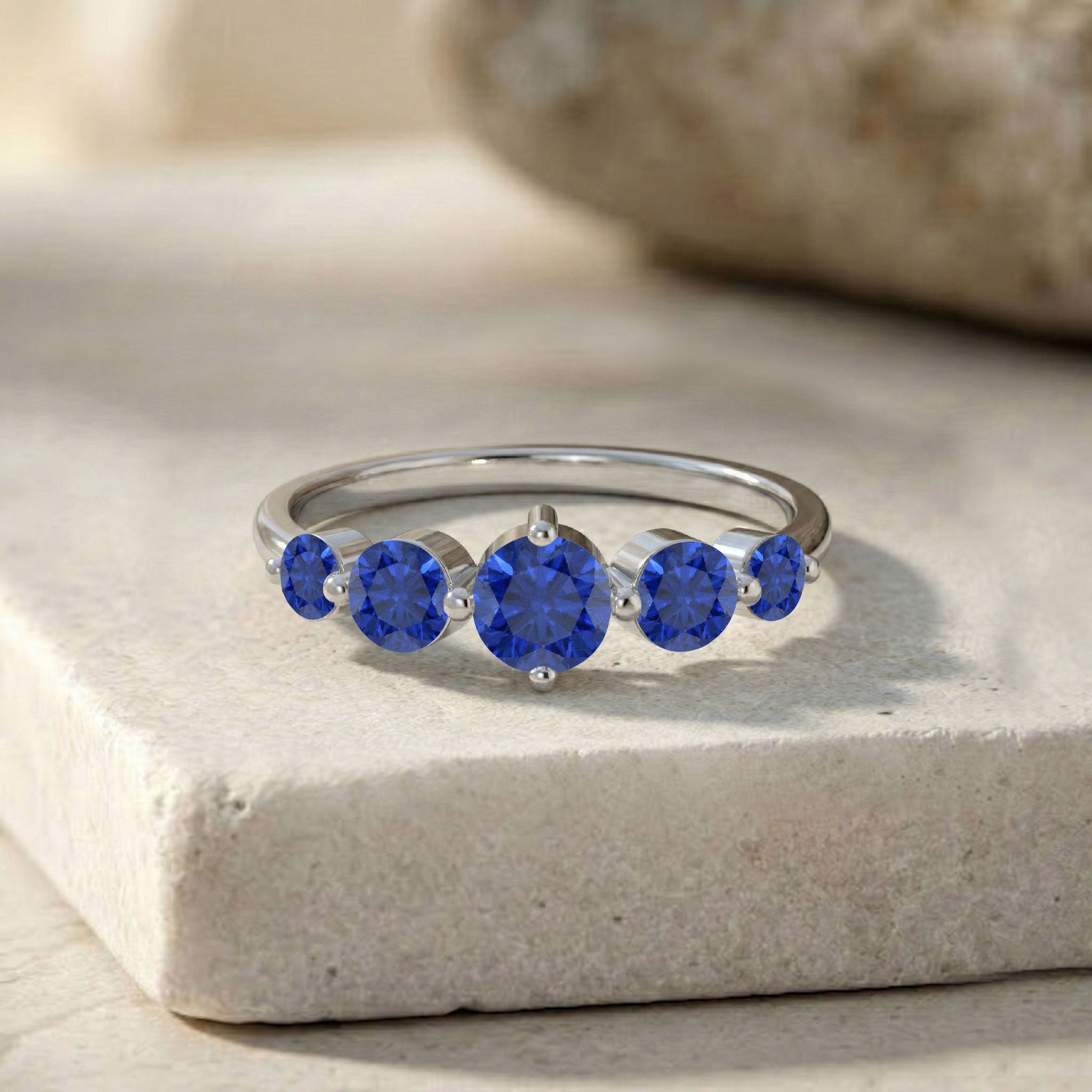 gold sapphire ring, elegant gemstone jewelry, five round stones, royal blue sparkle, anniversary gift women, birthday jewelry, stylish sapphire band, graceful ring design, everyday luxury, fine gemstone ring, luxury accessory, timeless fashion jewelry, sophisticated gift, premium ring style, elegant women's jewelry