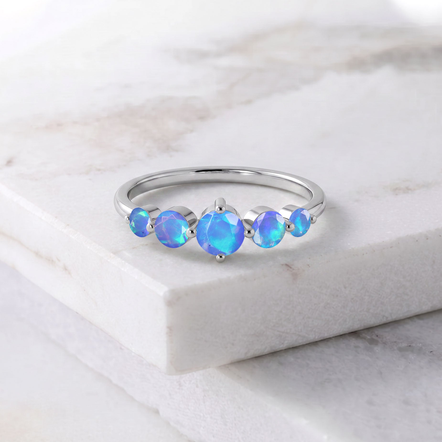 natural blue opal gemstone ring, handcrafted artisan jewelry, sterling silver elegant ring, yellow gold filled luxury jewelry, vibrant round opals, five stone jewelry, polished comfort ring, anniversary jewelry, women's gift, premium gemstone craftsmanship, refined fashion accessory, minimalist jewelry, glowing gemstone ring, timeless elegance, everyday luxury