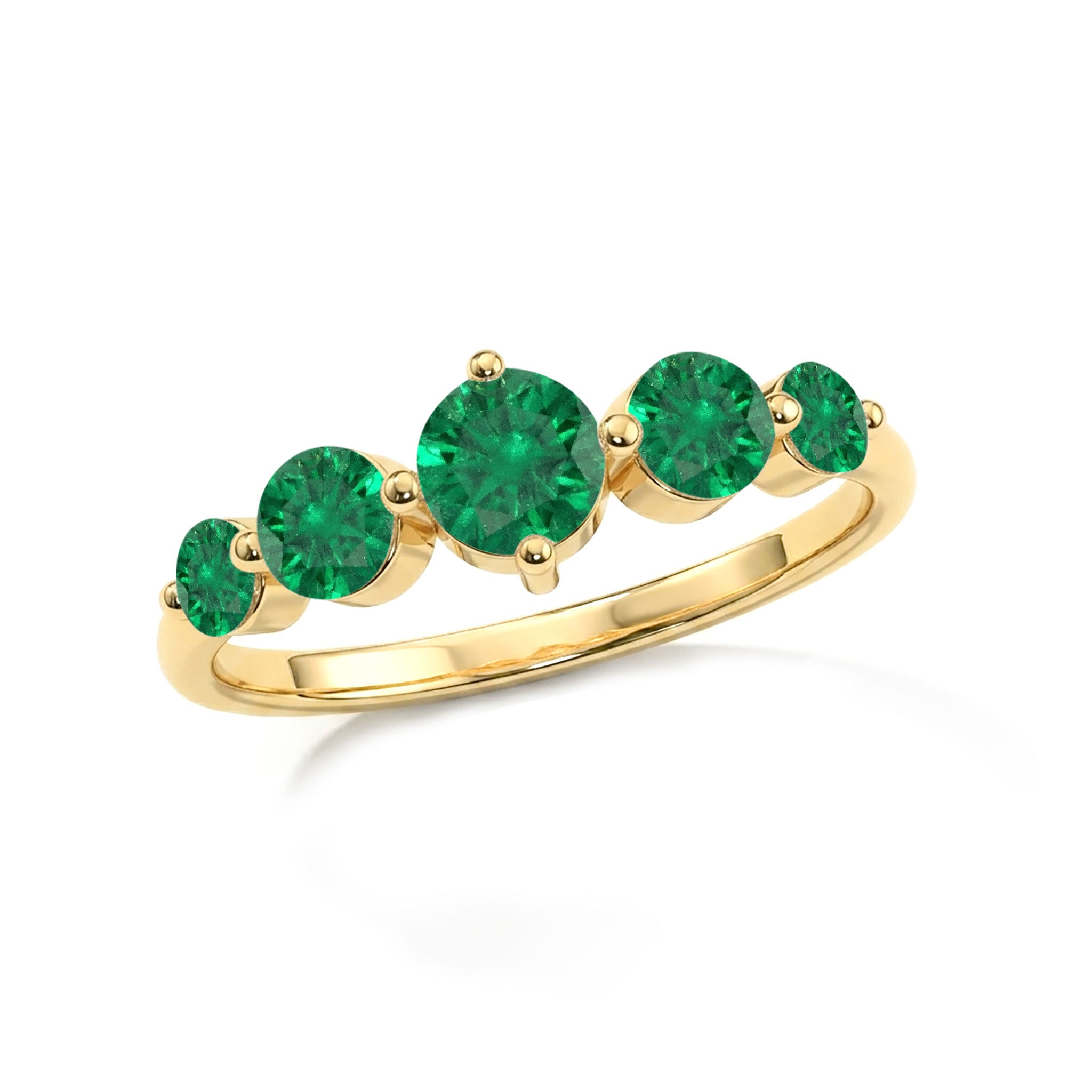 A yellow gold ring featuring five round-cut green gemstones of varying sizes, set against a clean white background.