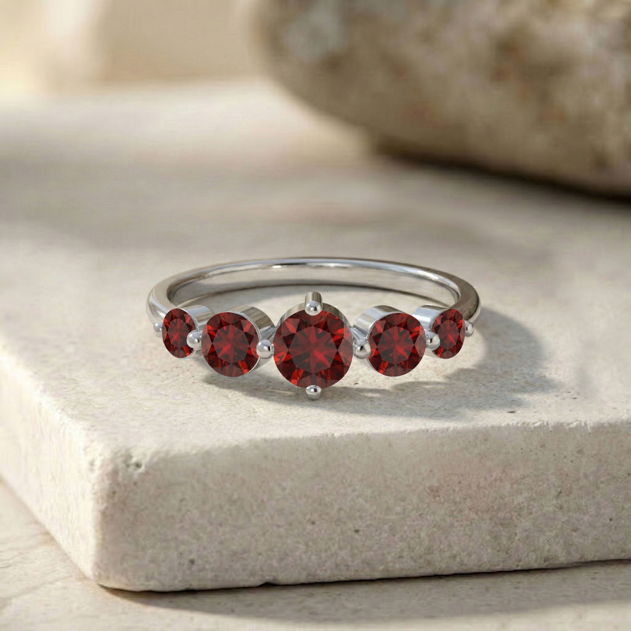 garnet engagement style ring, graduated round gemstone band, classic red gemstone jewelry, sterling silver luxury ring, yellow gold filled accessory, elegant fashion jewelry, handcrafted prong setting, women's stacking band, refined anniversary gift, brilliant gemstone sparkle, polished finish, delicate ring profile, timeless bridal accessory, artisan craftsmanship, everyday wear