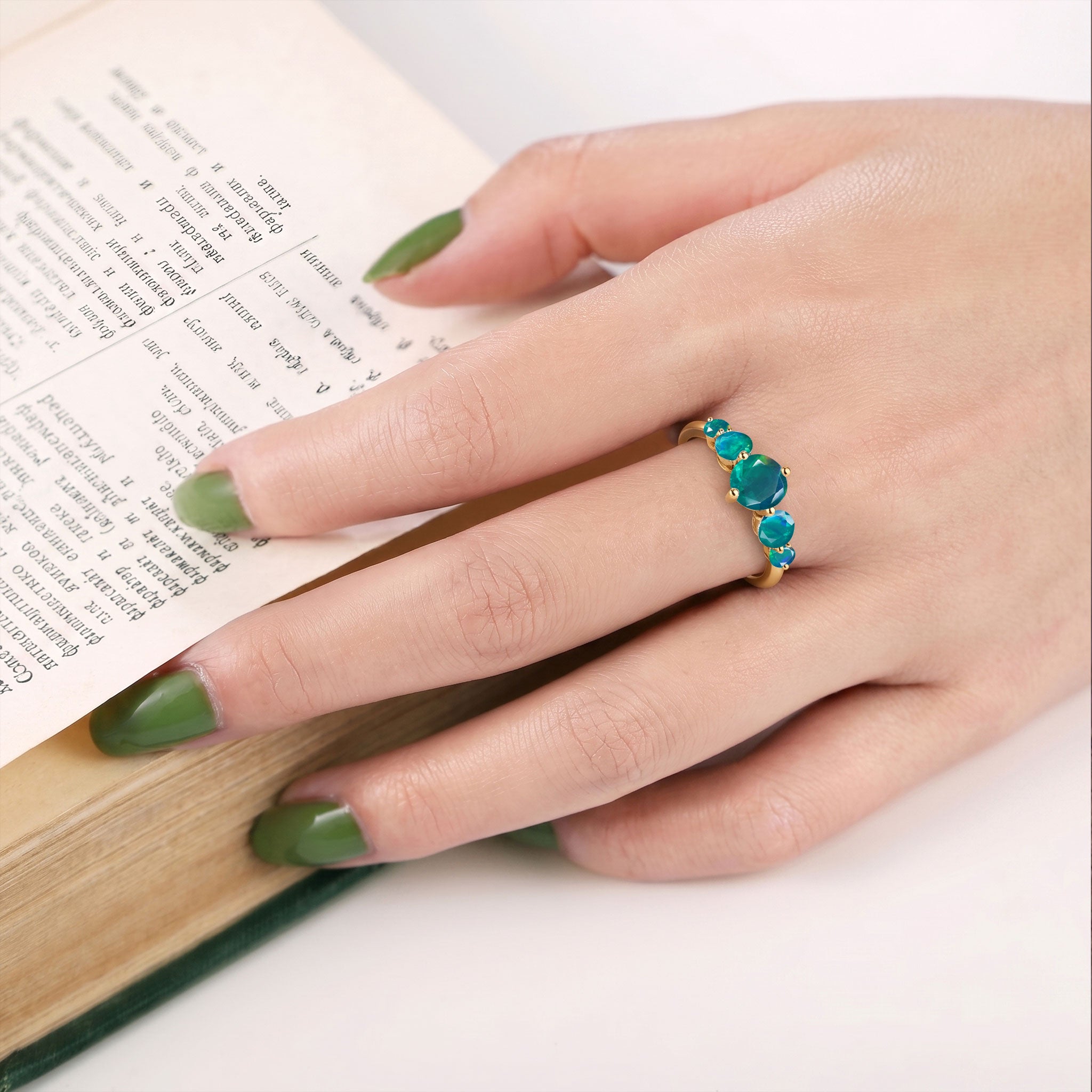 green opal gemstone jewelry, handcrafted ring, graduated gemstone layout, sterling silver option, yellow gold option, elegant craftsmanship, women's luxury jewelry, artisan gemstone design, fashion accessory, anniversary celebration, bridal inspiration, birthday jewelry, fine accessory, timeless design, polished gemstones, premium quality, sophisticated jewelry, everyday style, classic elegance, gift for her