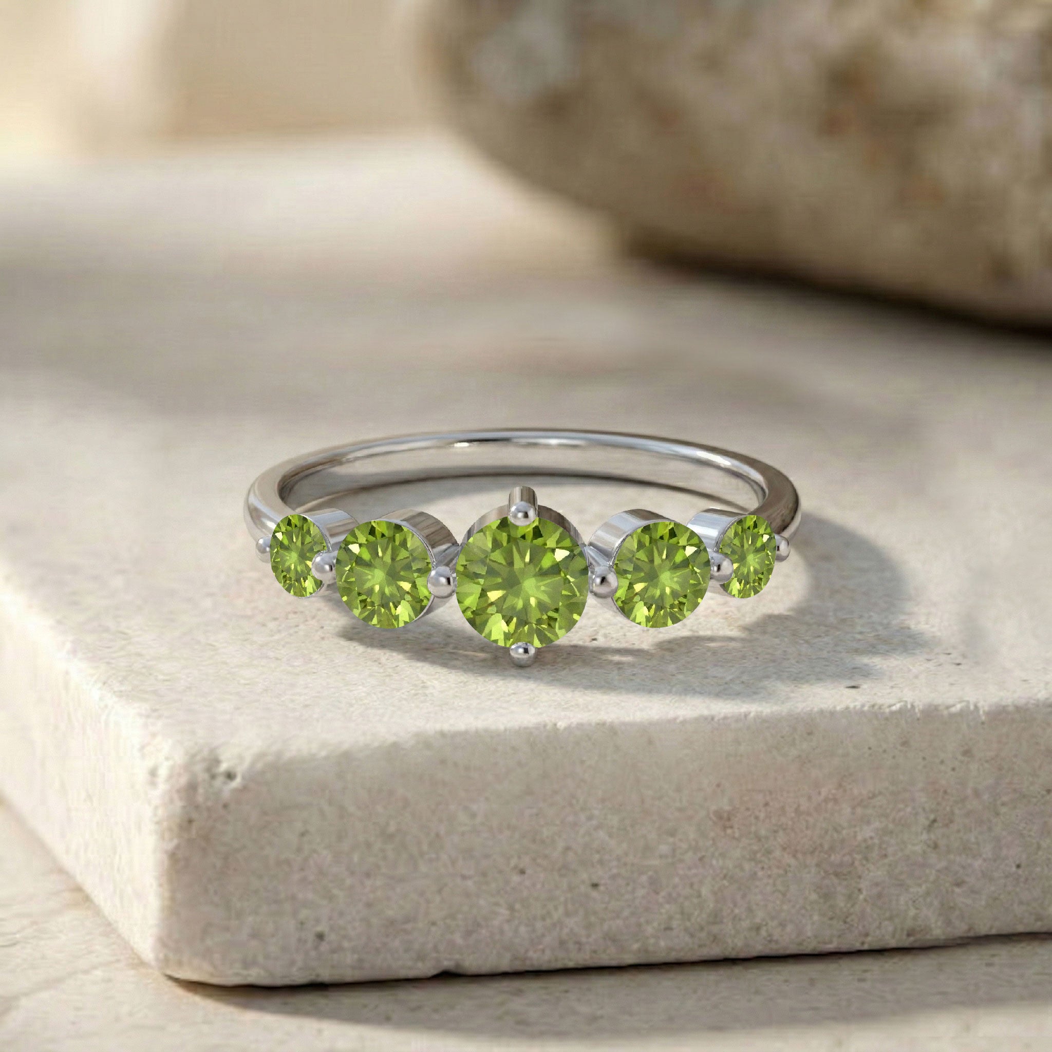 graduated gemstone arrangement, vivid green peridot ring, artisan jewellery craftsmanship, polished sterling silver finish, yellow gold filled luxury, premium gemstone sparkle, elevated centre stone design, elegant women's ring, August birthstone jewellery, handcrafted statement piece, modern heirloom jewellery, comfortable ring profile, timeless styling, luxury accessory, exclusive design