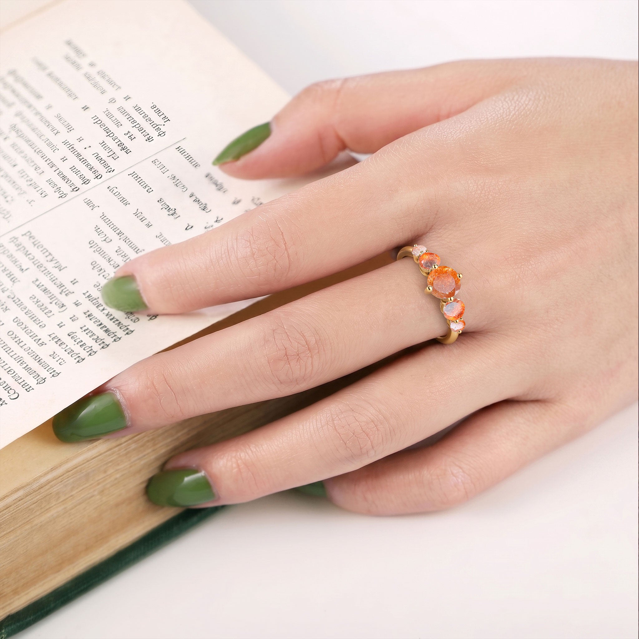 graduated sunstone ring, natural gemstone jewelry, round orange gemstones, sterling silver craftsmanship, yellow gold filled option, elegant handcrafted jewelry, anniversary keepsake, bridal jewelry, luxury ring design, feminine style, polished gemstone setting, timeless elegance, sophisticated jewelry, gift for women, premium craftsmanship