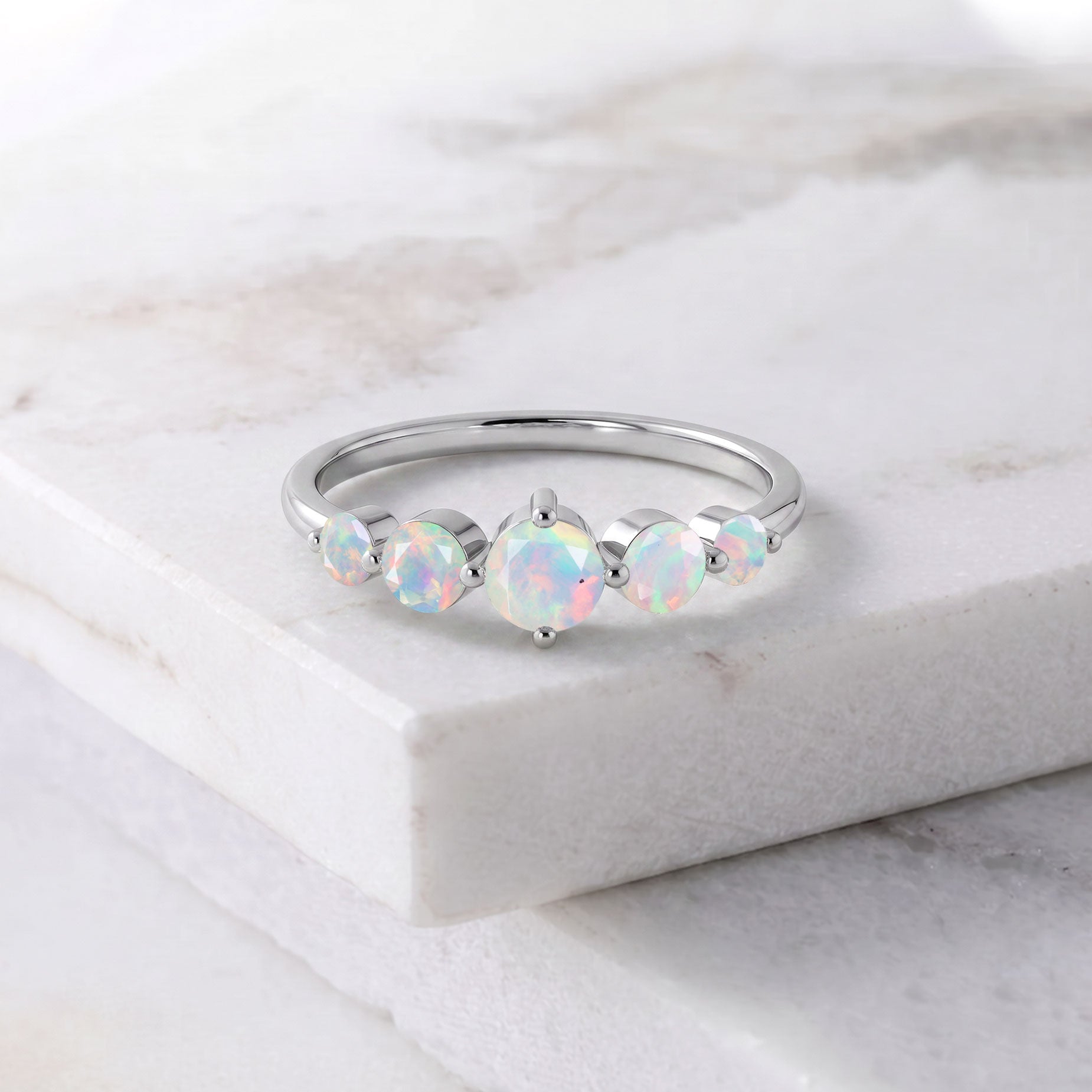 natural white gemstone ring, october birthstone accessory, colorful opal jewelry, graduated design, polished sterling silver, yellow gold jewelry, sophisticated jewelry, luxury gift, elegant gemstone accessory, handmade fine jewelry, romantic jewelry, stacking style, bridal fashion, anniversary keepsake, artisan ring, modern jewelry, classic style, premium quality, everyday wear, unique gemstone
