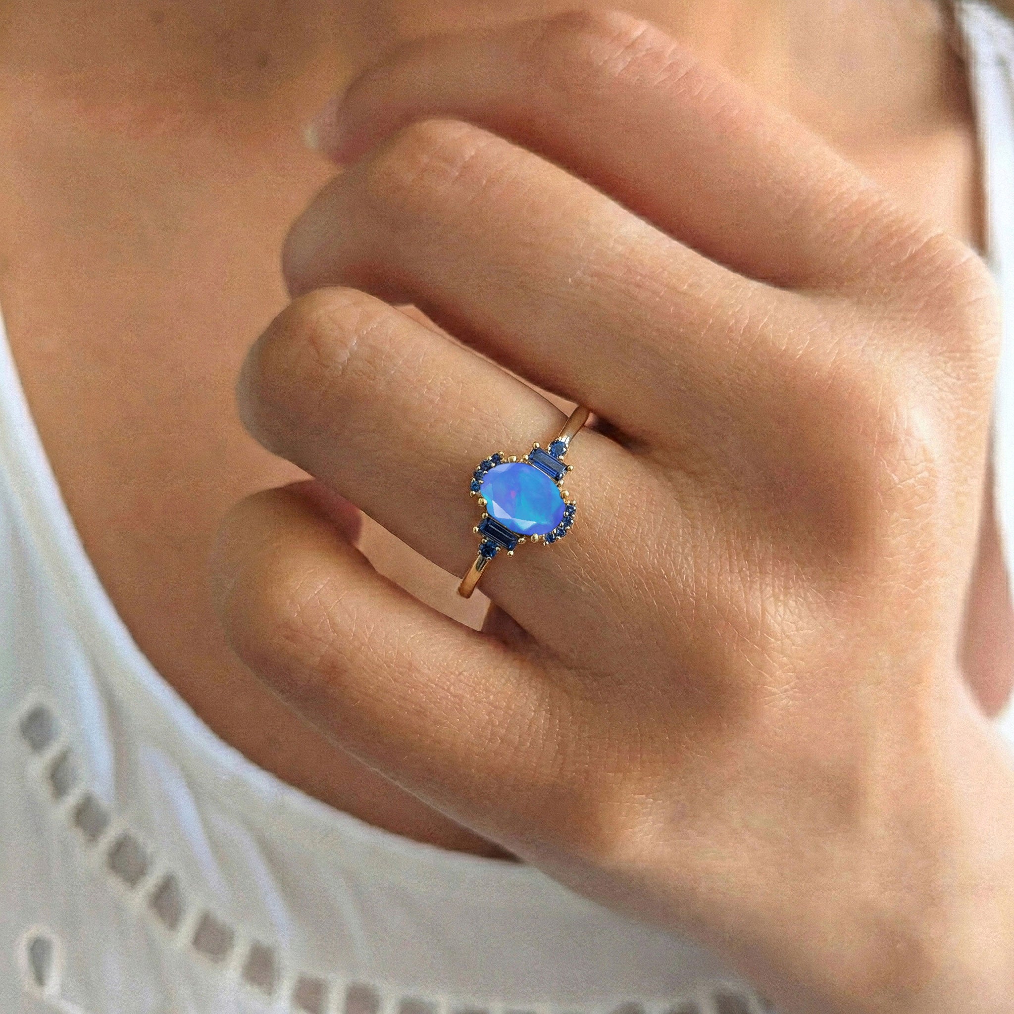 Close up blue opal gemstone ring with blue sapphire side stones 1.2 carat jewelry