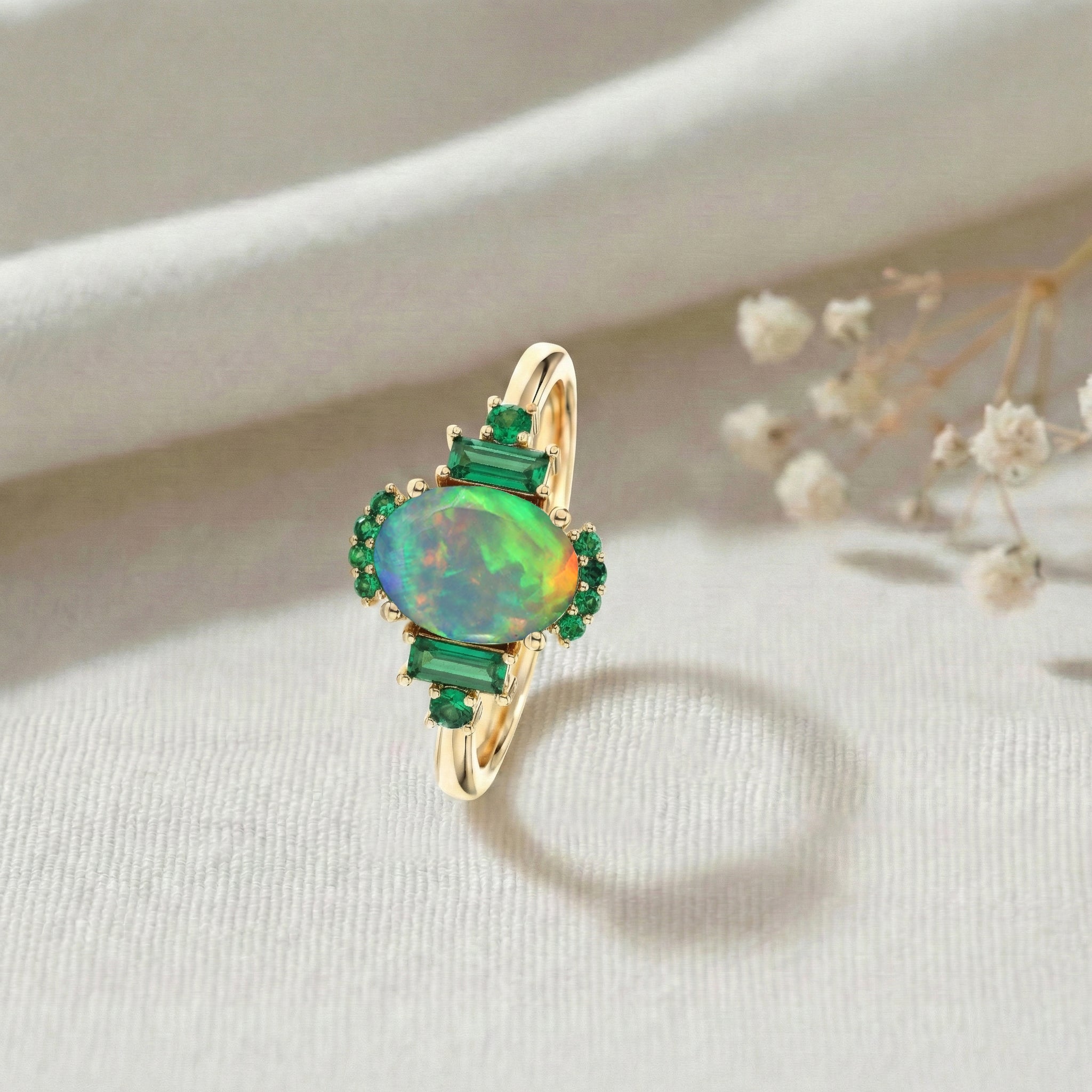 Vintage style black opal engagement ring with emerald accents oval gemstone design