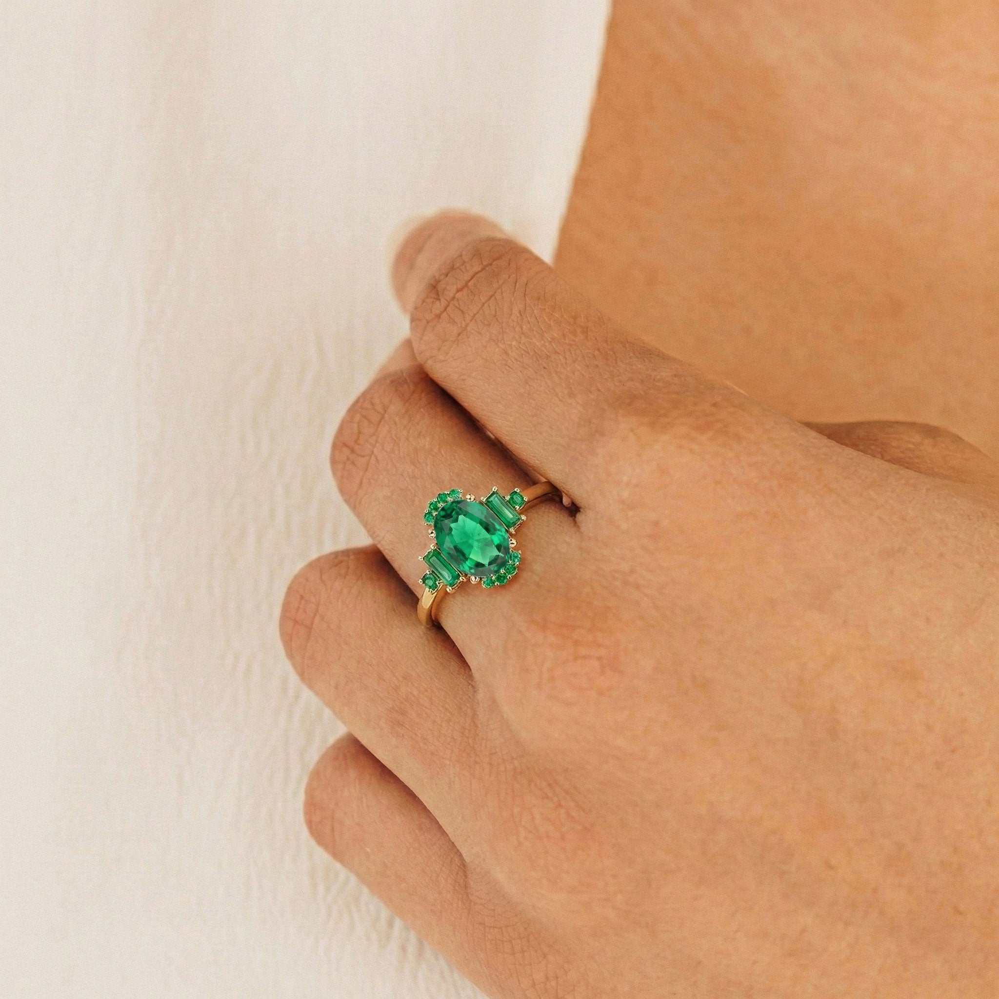 Close up view of emerald ring with 8x6 mm green gemstones in 925 sterling silver setting