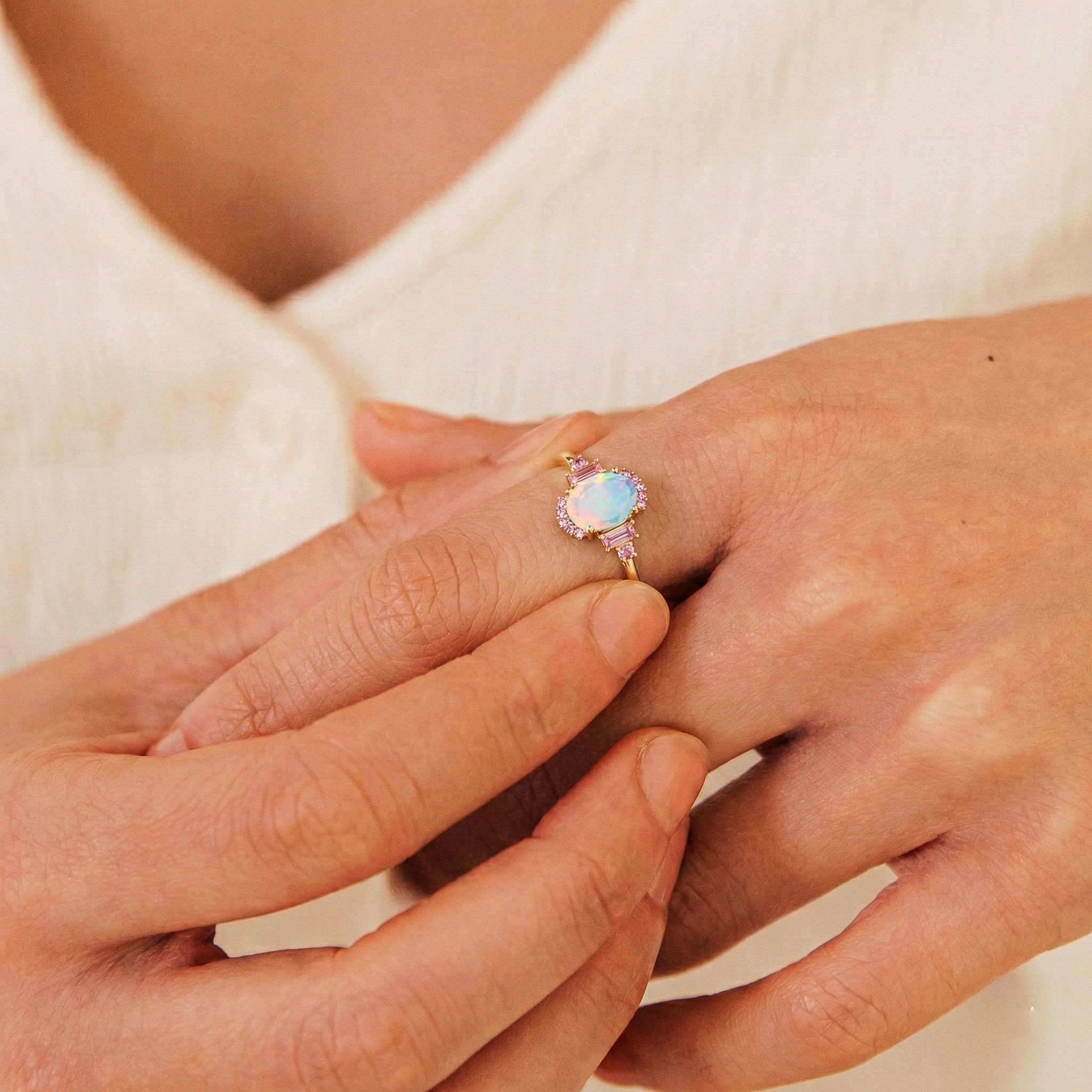 Elegant bridal engagement ring featuring white opal and pink tourmaline in sterling silver jewelry
