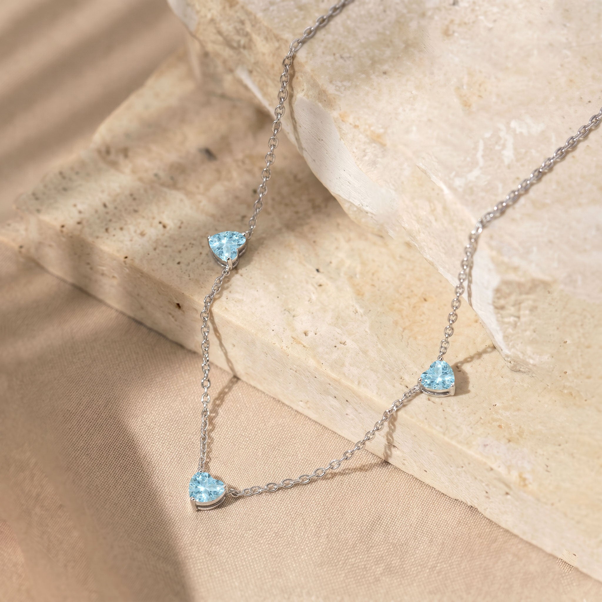 Genuine AAA Aquamarine heart necklace with three 6mm heart-cut gemstones.
