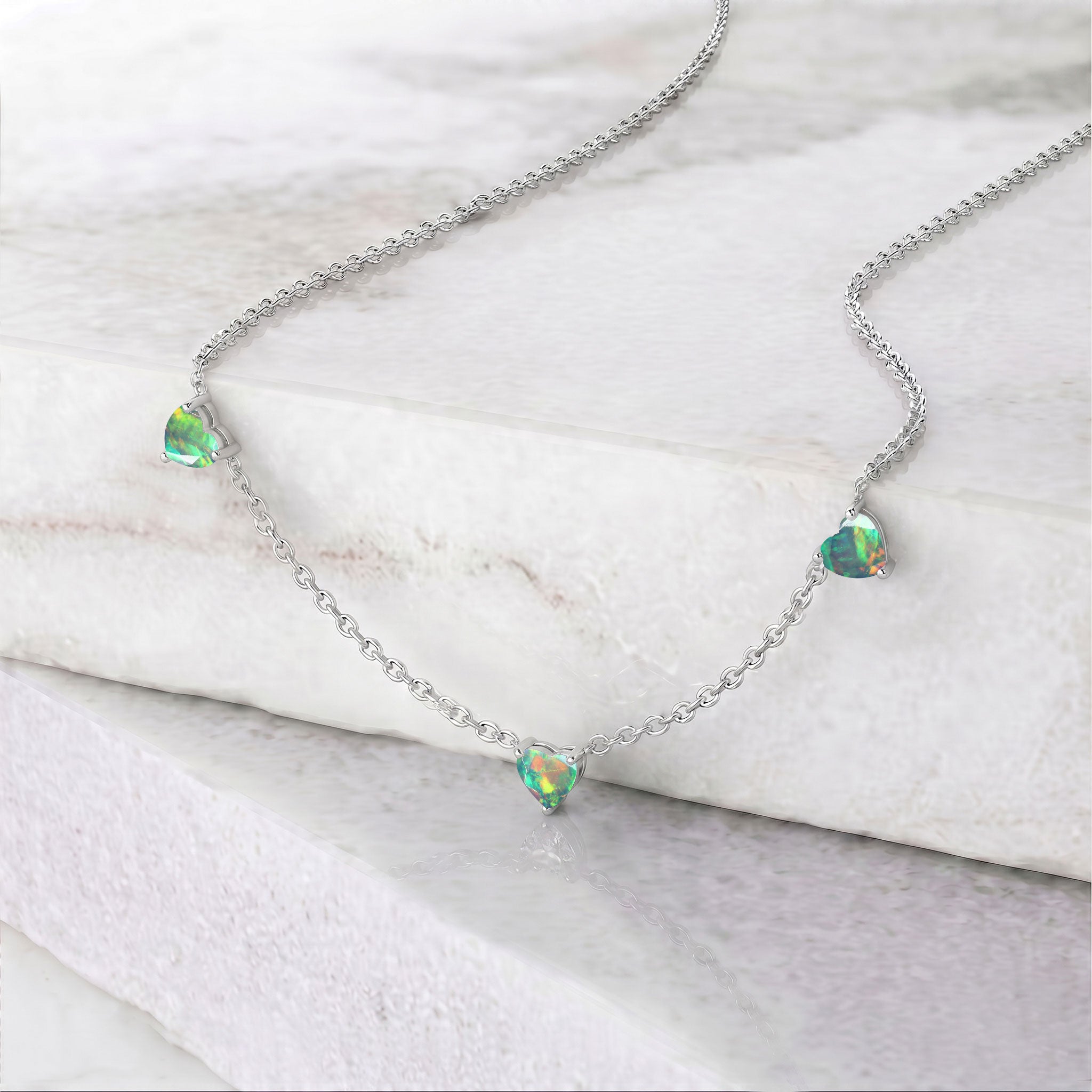 Genuine AAA Natural Black Opal Heart Necklace with three 6mm heart-cut gemstones.
