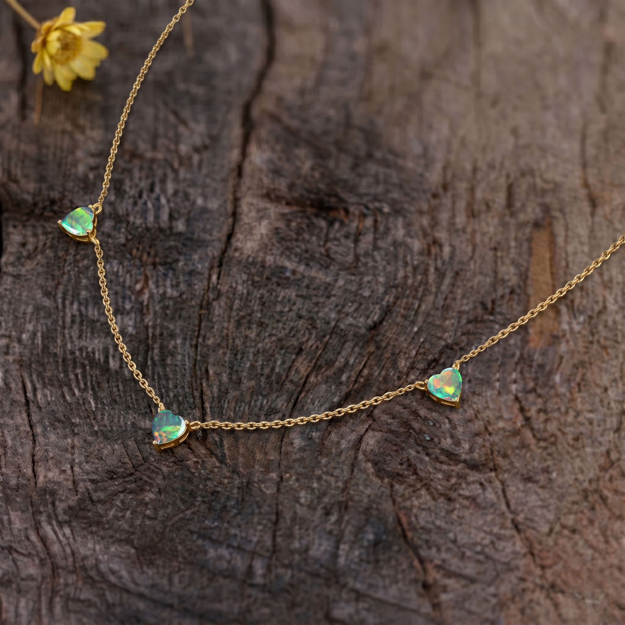 AAA Grade Natural Black Opal Heart Necklace featuring three genuine 6mm heart-cut opals in 925 Sterling Silver.
