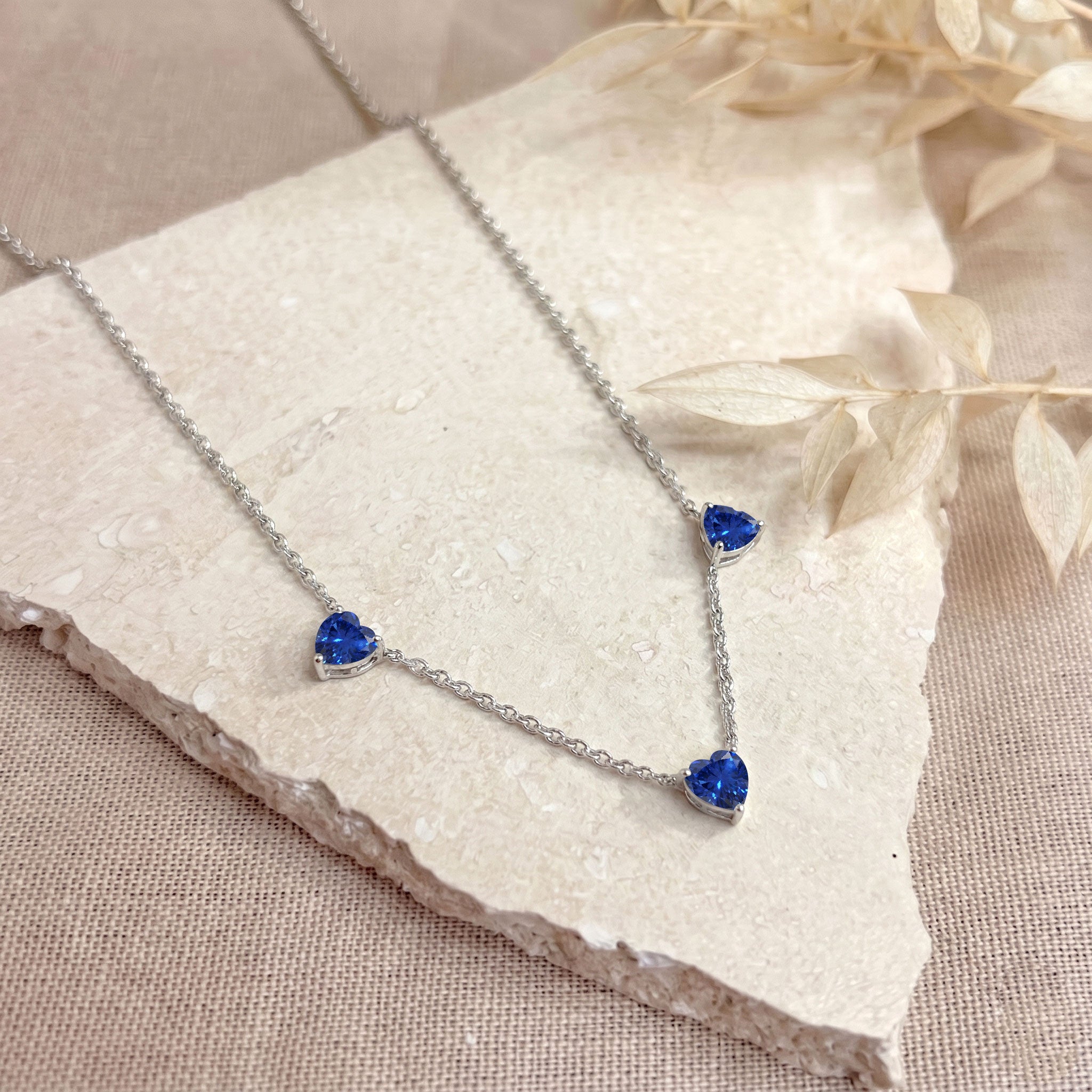 Genuine AAA Blue Sapphire Heart Necklace with three 6mm heart-cut gemstones.
