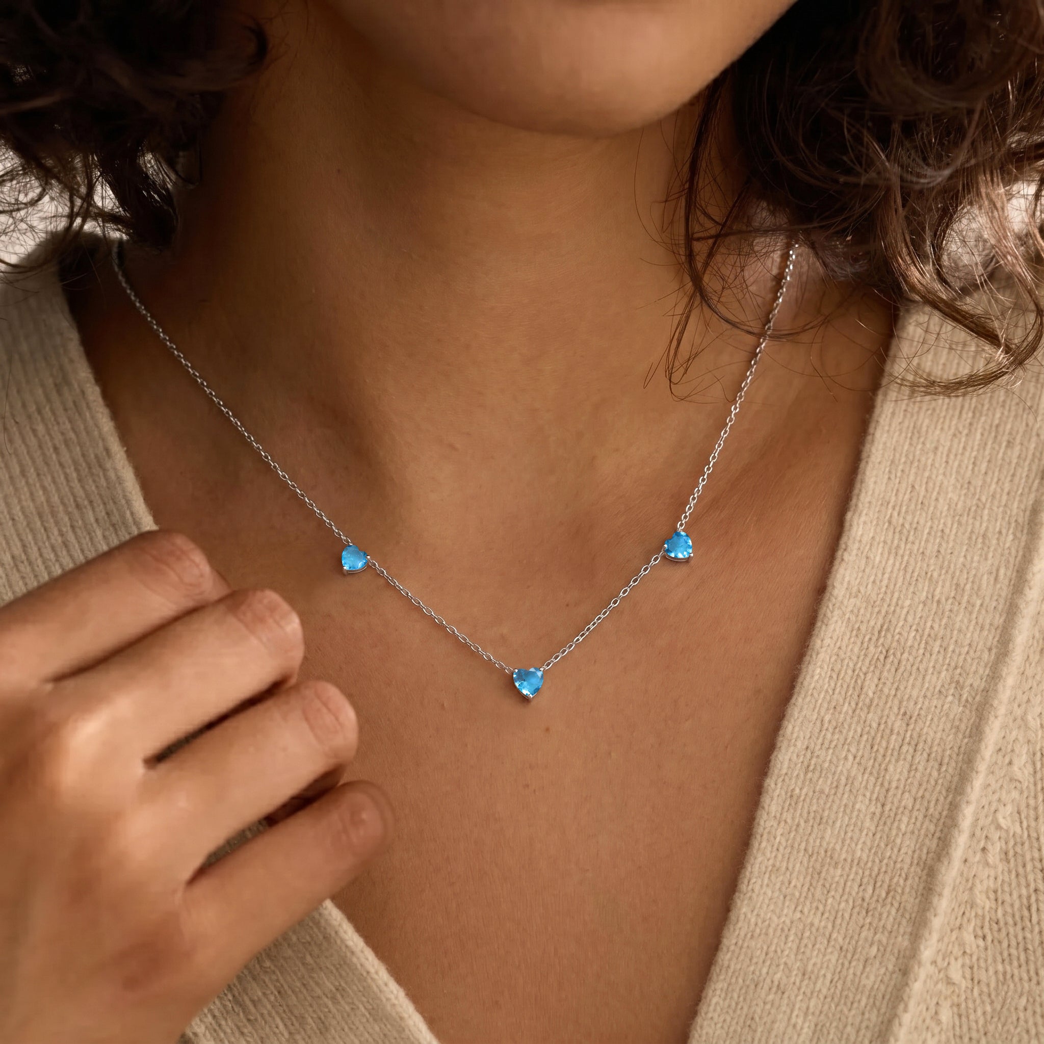 Natural Blue Topaz Three Stone Heart Necklace available in Sterling Silver, Yellow Gold Filled, and Rose Gold Filled.
