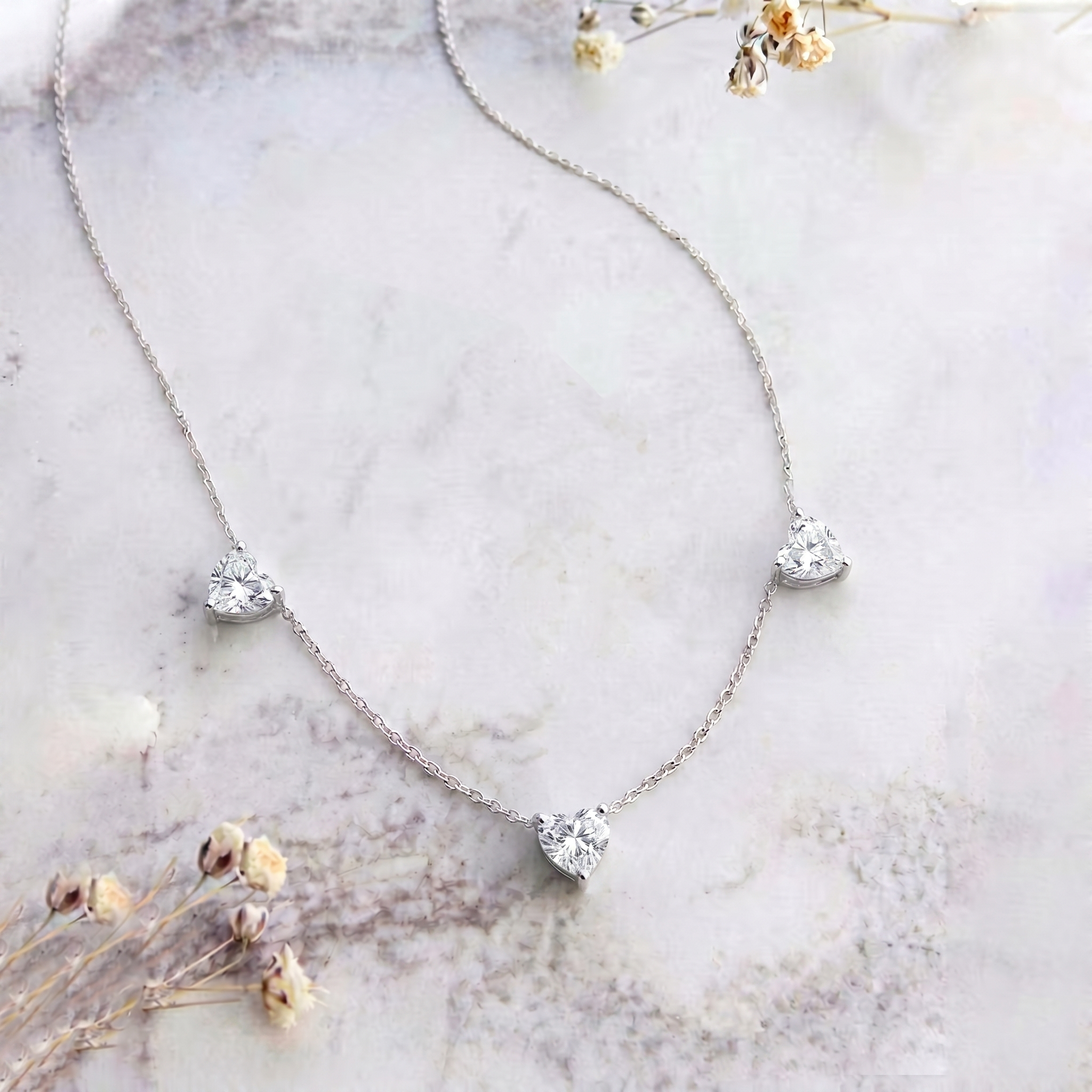 Elegant Natural Moissanite Three Stone Heart Necklace with brilliant sparkling gemstones.
