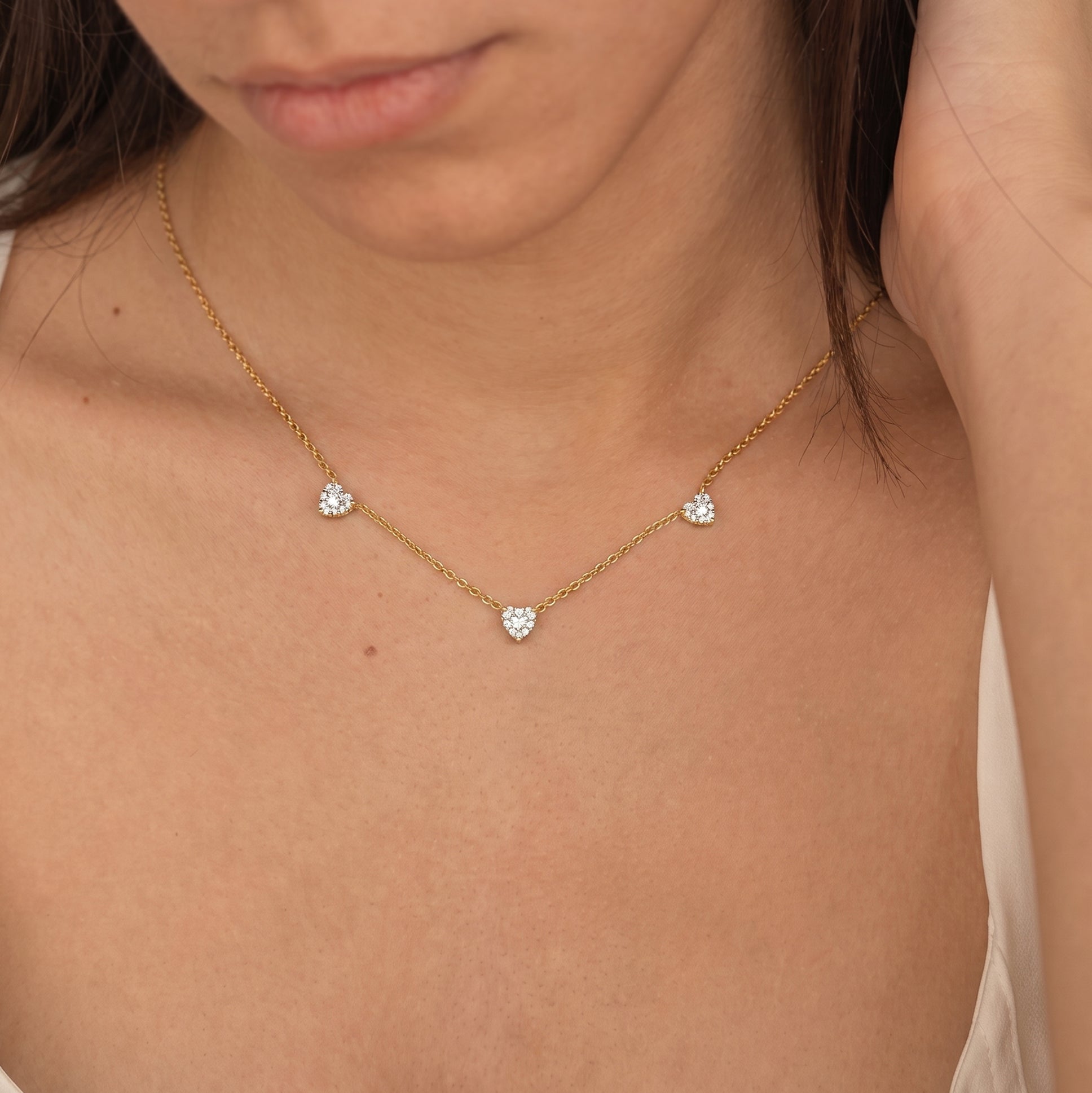 Rose Gold Filled Natural Moissanite Three Stone Heart Necklace with heart-cut gemstones.
