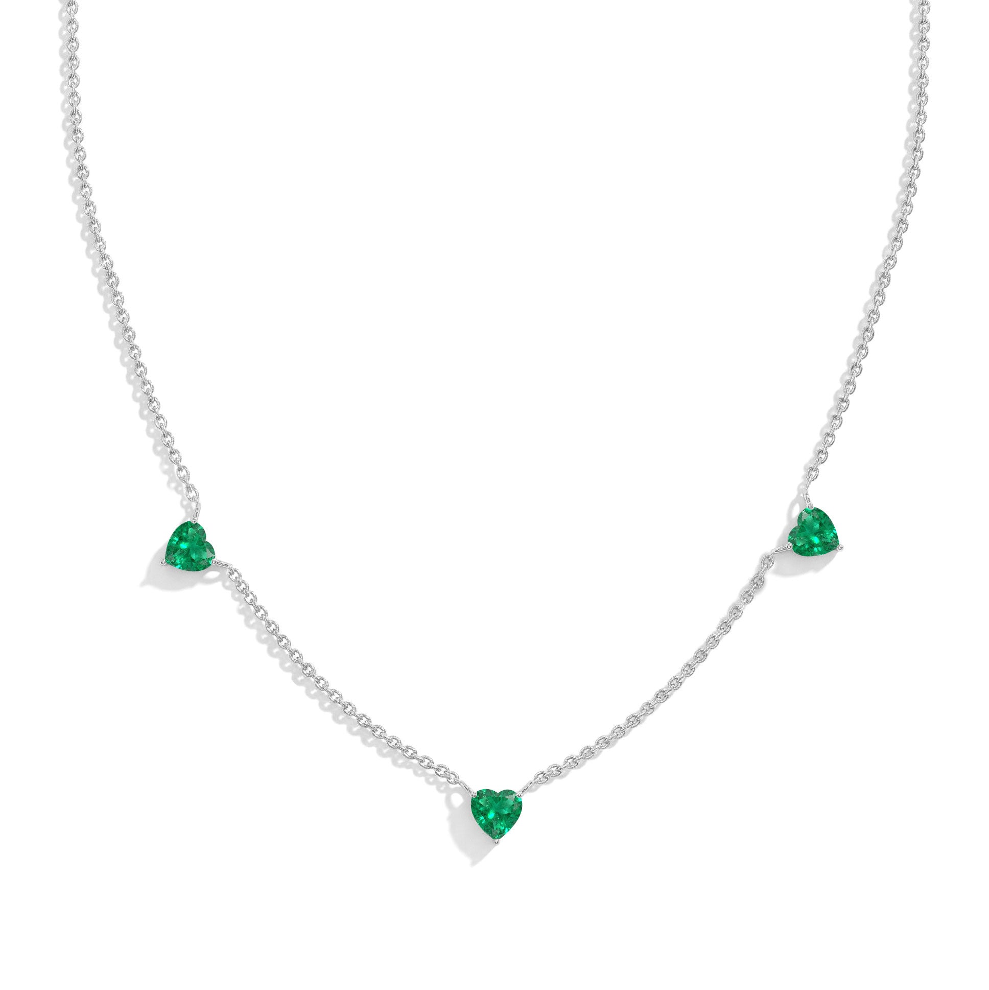 "AAA Grade Emerald Three Stone Heart Necklace in 925 Sterling Silver with genuine heart-cut gemstones.

