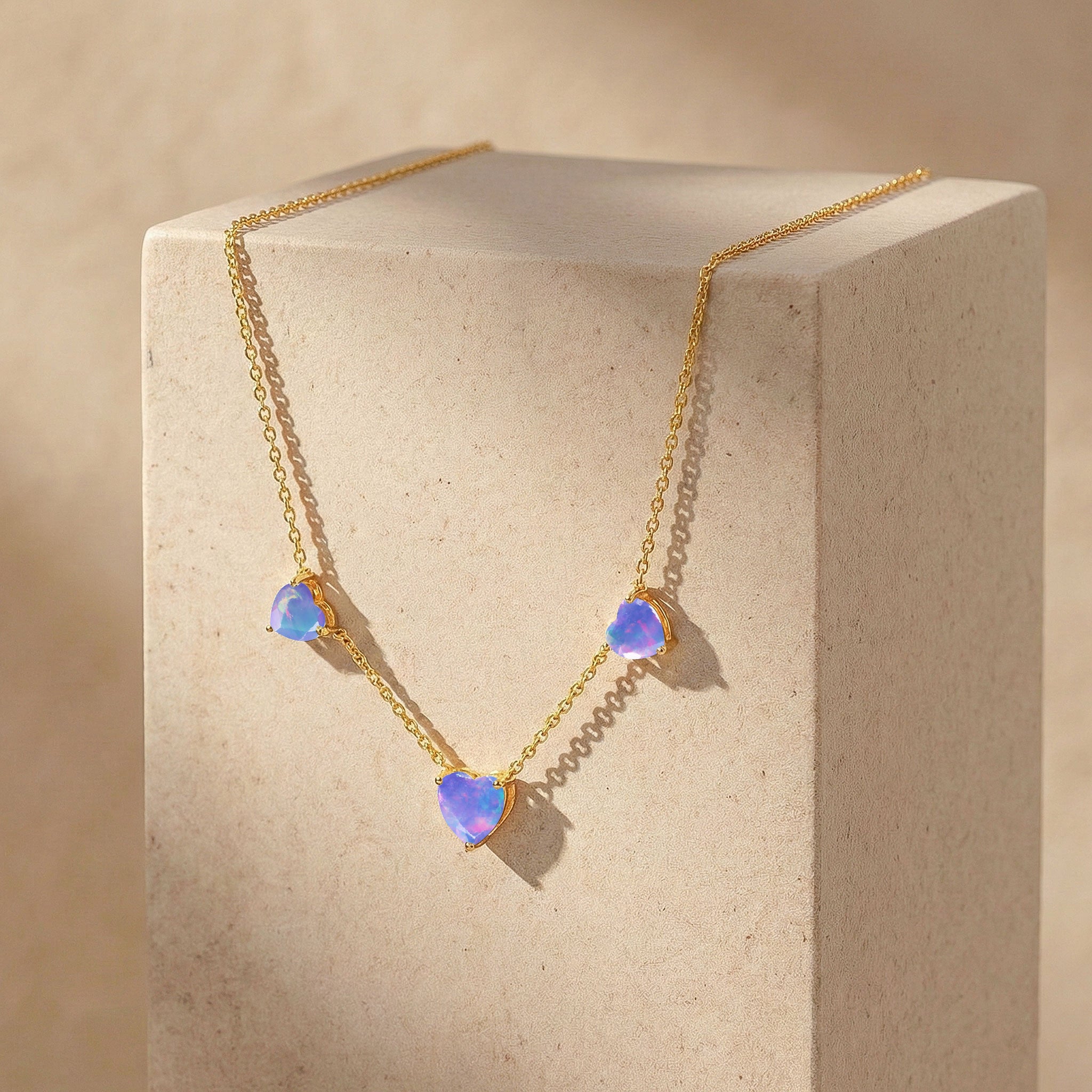 Elegant Lavender Opal Three Stone Heart Necklace with soft lavender opal gemstones.
