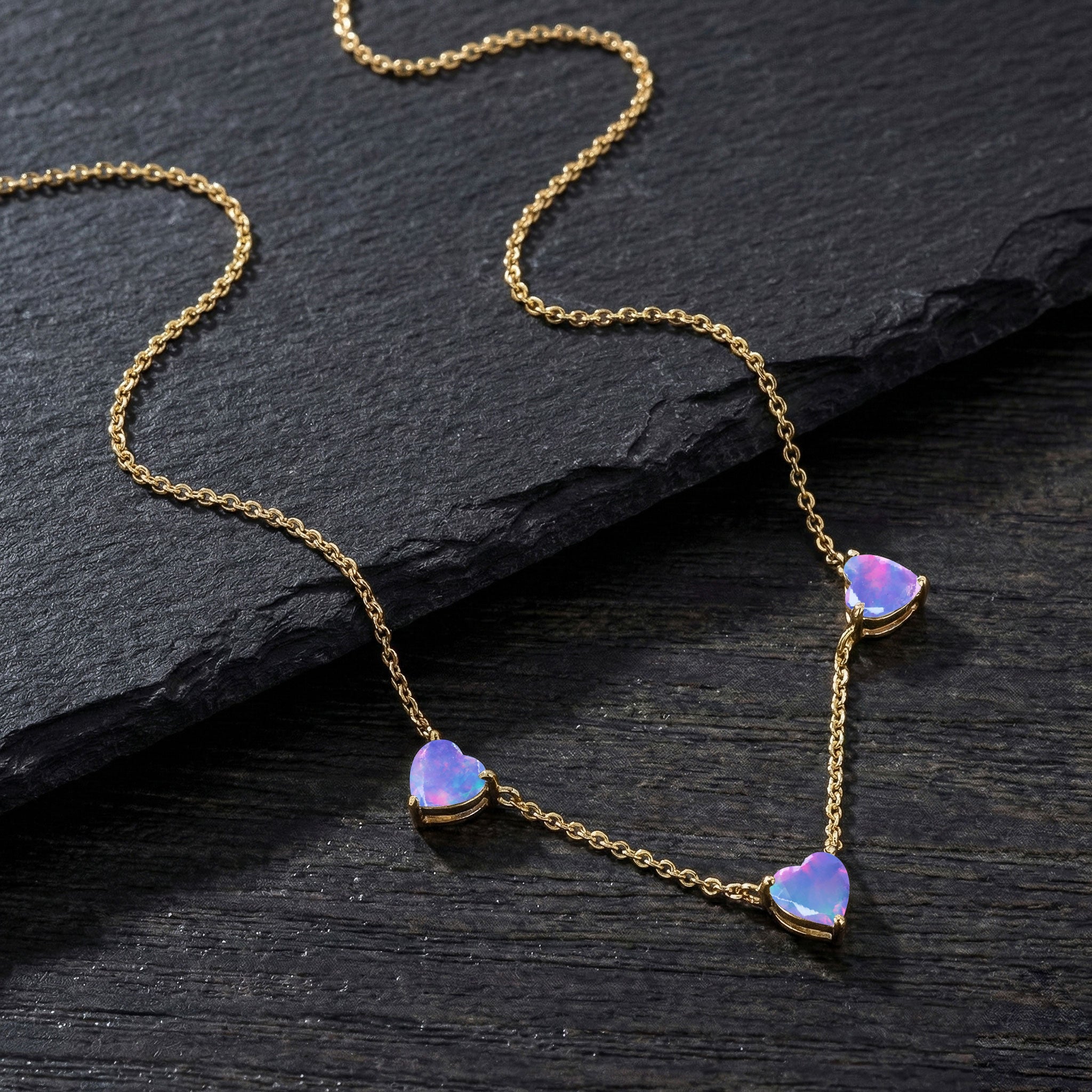 Fine jewelry Lavender Opal necklace with three heart-shaped gemstones.
