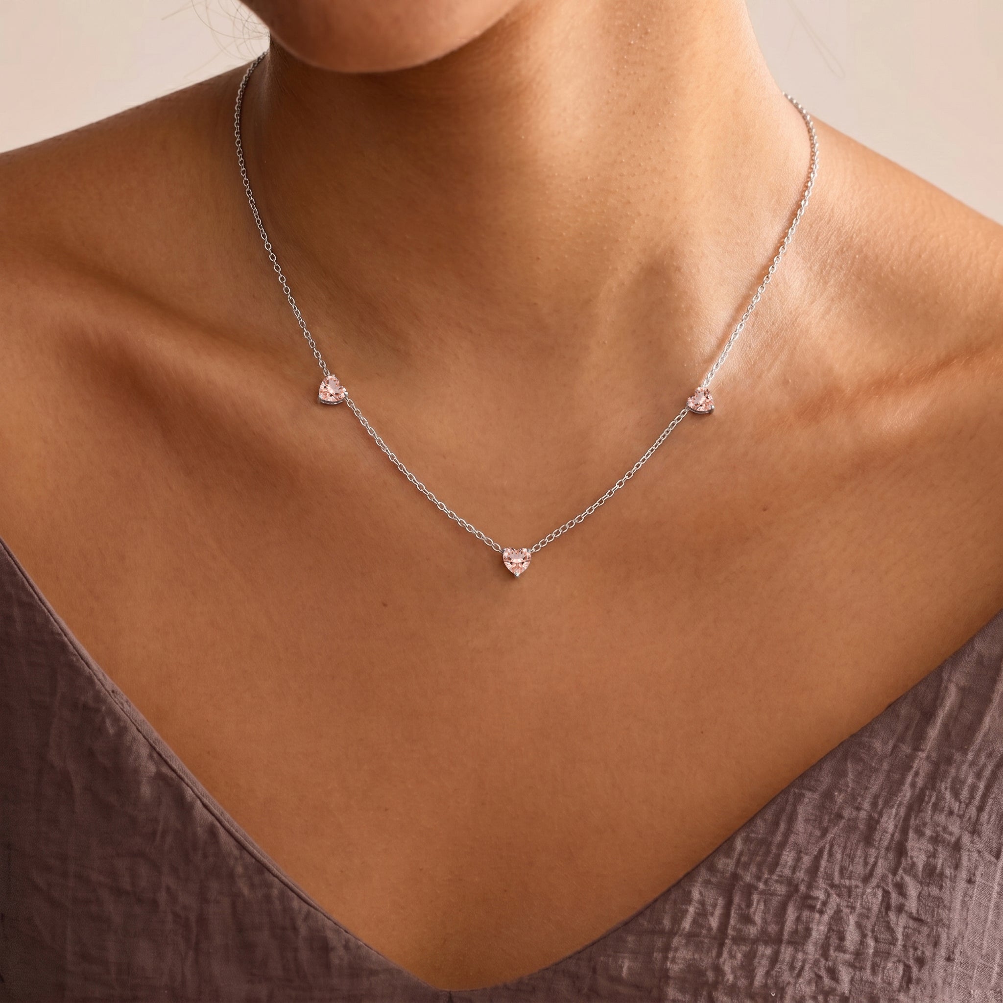 Elegant Morganite Three Stone Heart Necklace with blush pink gemstones.
