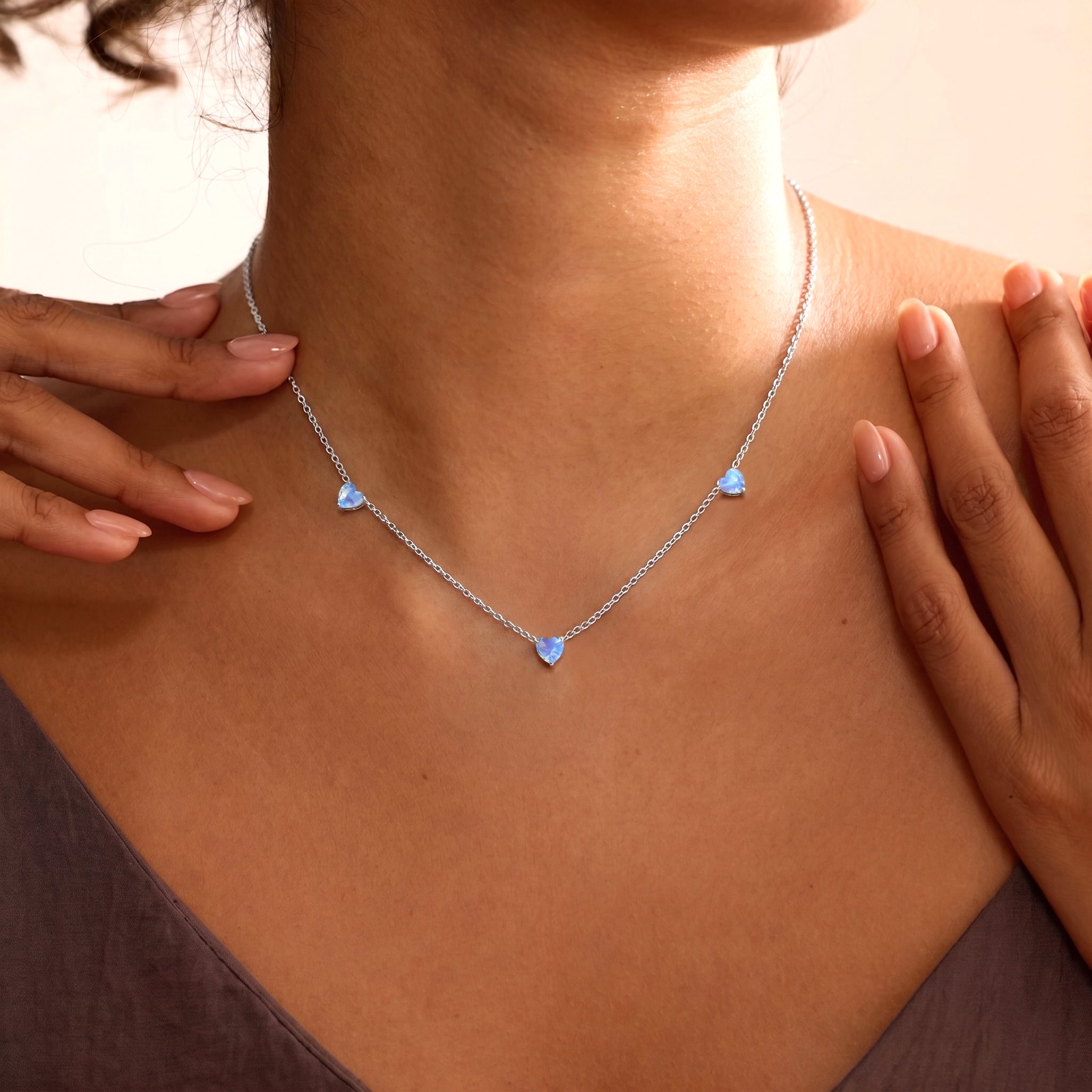 Elegant Natural Moonstone Three Stone Heart Necklace with glowing gemstones.
