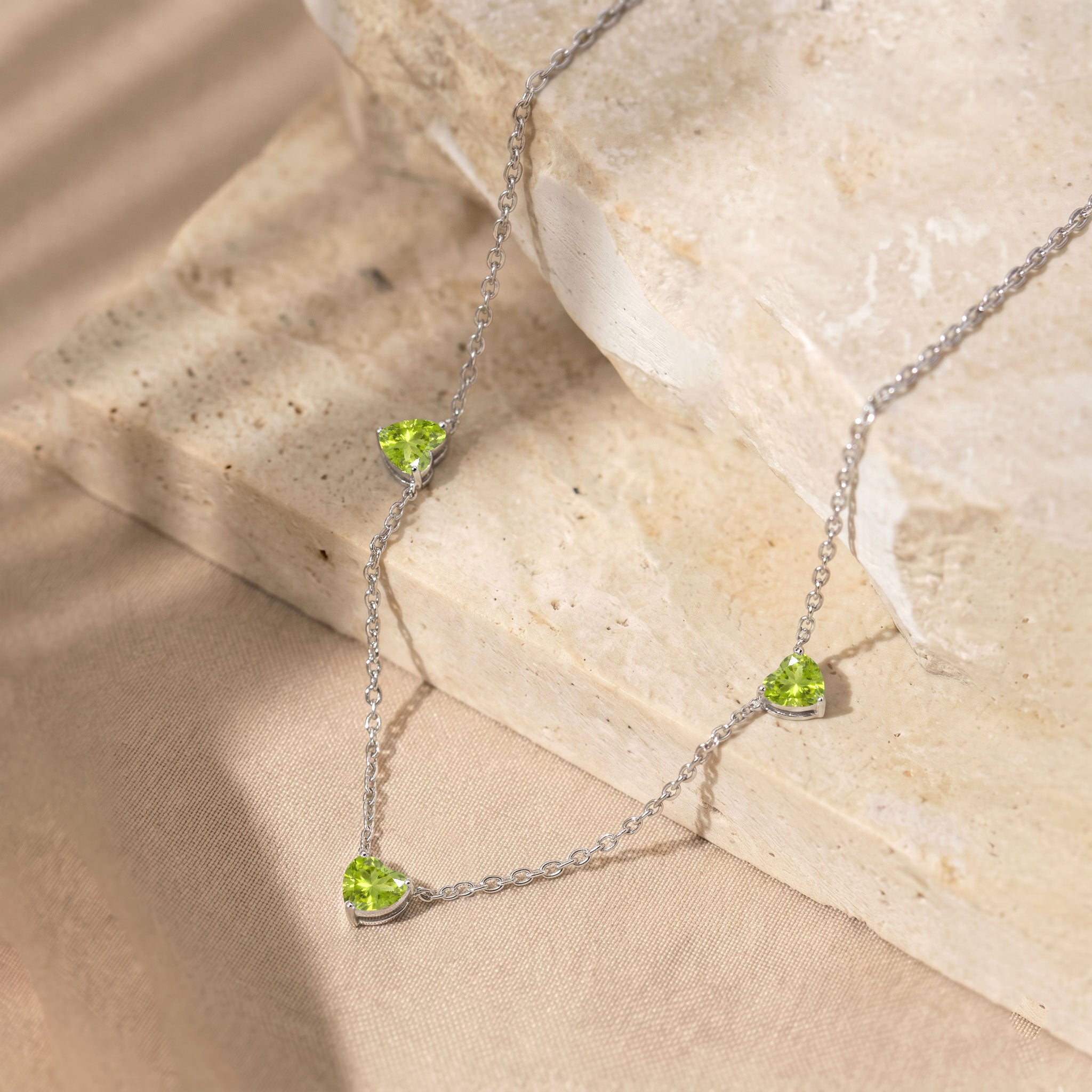 Elegant Natural Peridot Three Stone Heart Necklace with genuine green gemstones.
