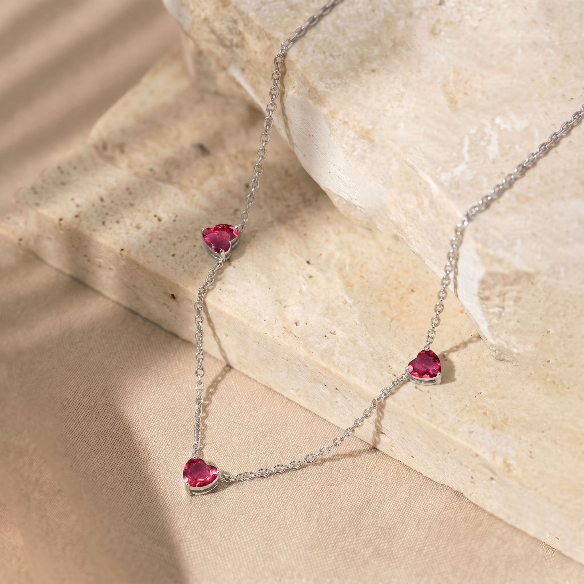 Elegant Pink Tourmaline Three Stone Heart Necklace with genuine gemstones.
