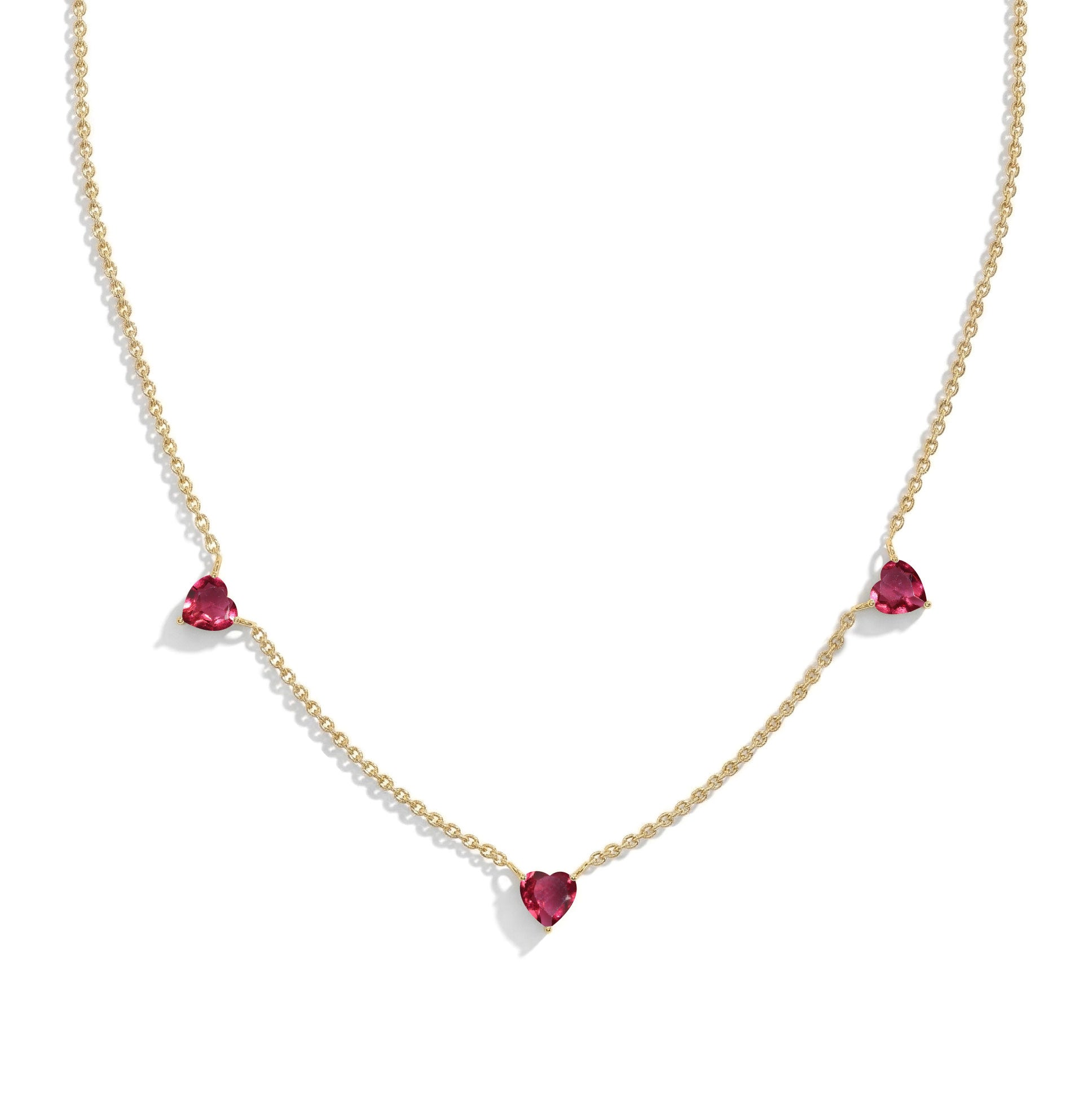 Handmade Pink Tourmaline Three Stone Heart Necklace in Yellow Gold Filled featuring three heart gemstones.
