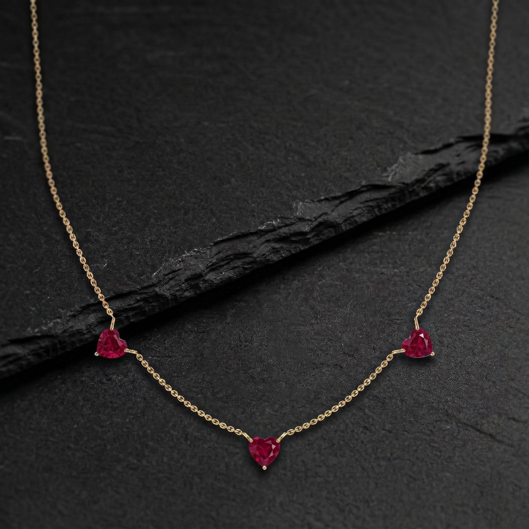 Handmade Ruby Three Stone Heart Necklace in yellow gold filled for women.
