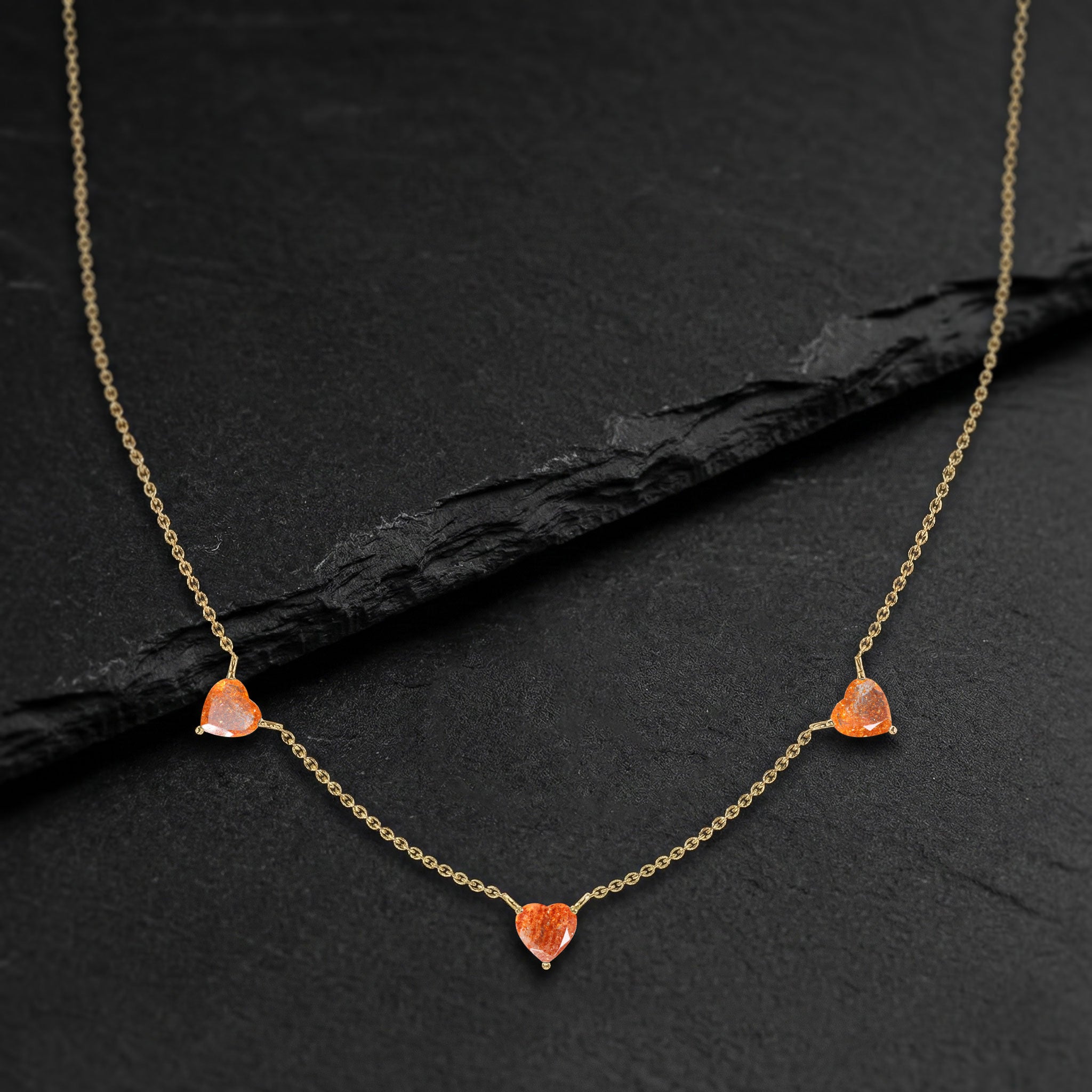 Minimalist Natural Sunstone Necklace with three heart-cut gemstones in sterling silver.
