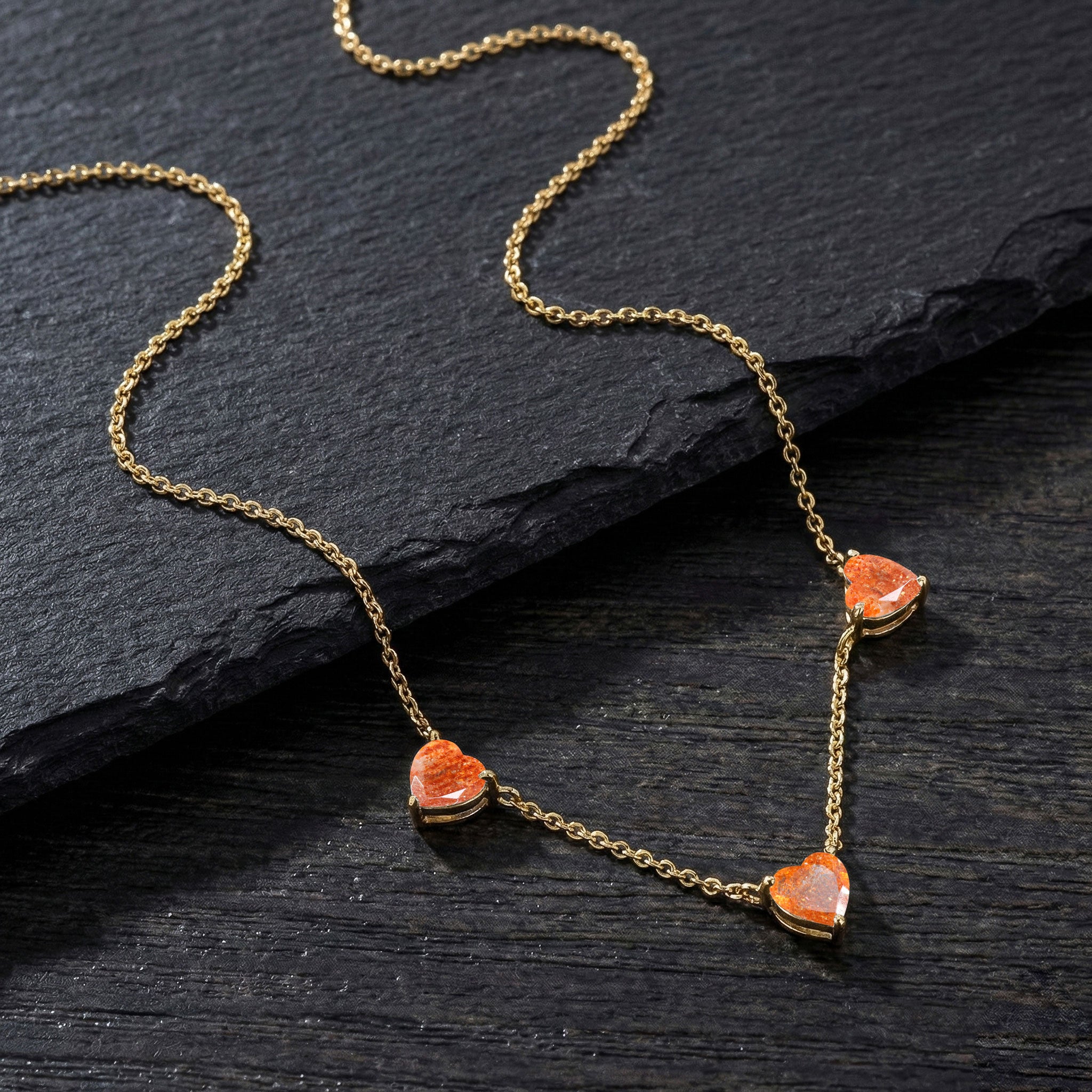 Handcrafted Sunstone Three Stone Heart Necklace available in sterling silver and gold filled.

