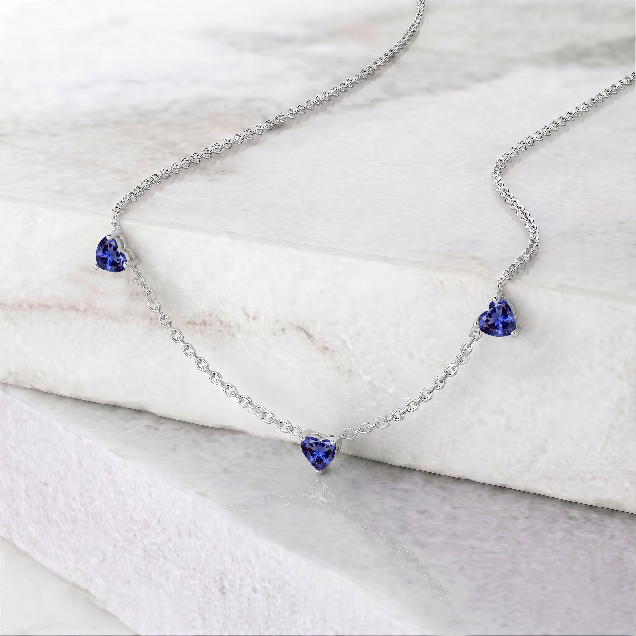 Genuine AAA Tanzanite Heart Necklace with three 6mm heart-cut gemstones.
