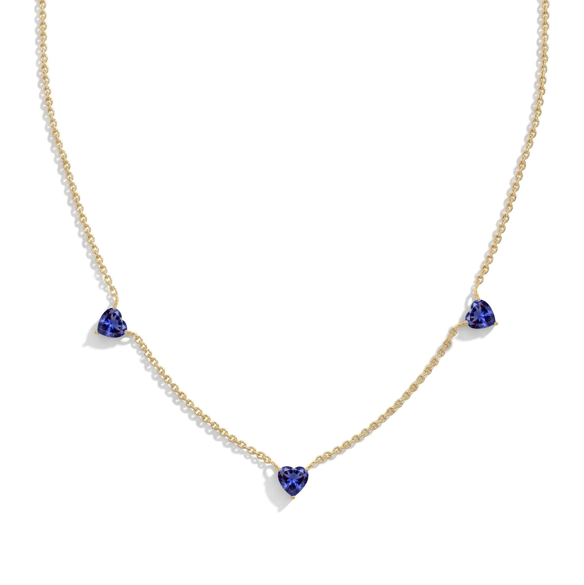 Fine jewelry Tanzanite necklace with three heart-shaped gemstones.
