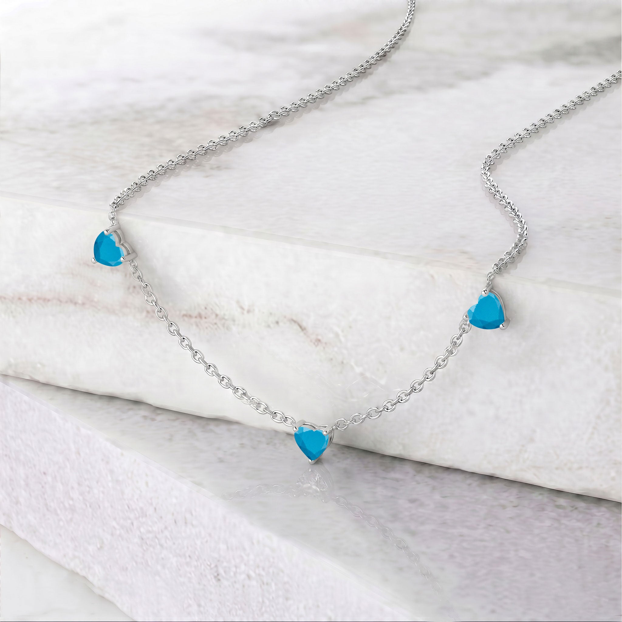Elegant Natural Turquoise Three Stone Heart Necklace with genuine blue-green gemstones.
