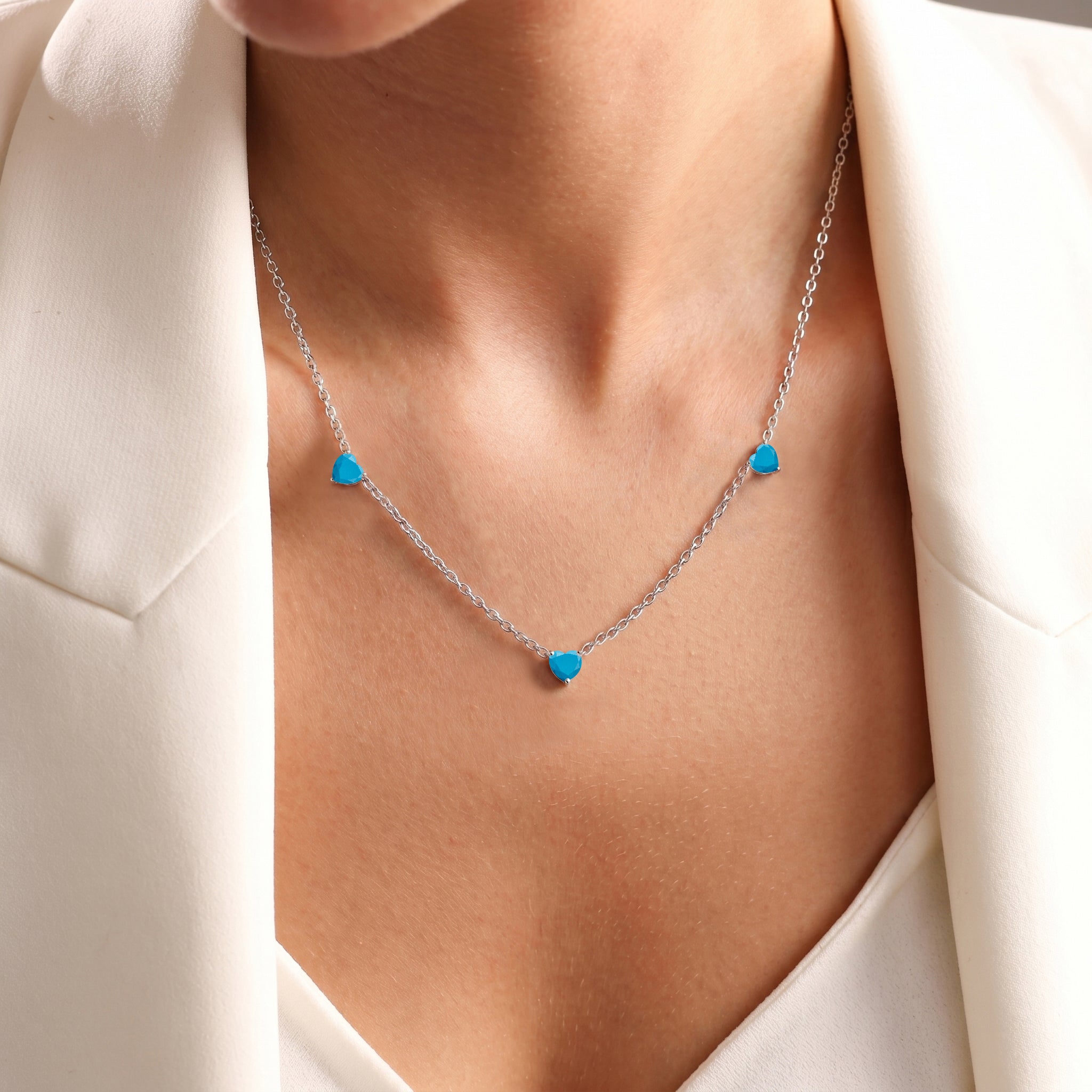 Fine jewelry Natural Turquoise necklace with three heart-shaped gemstones.

