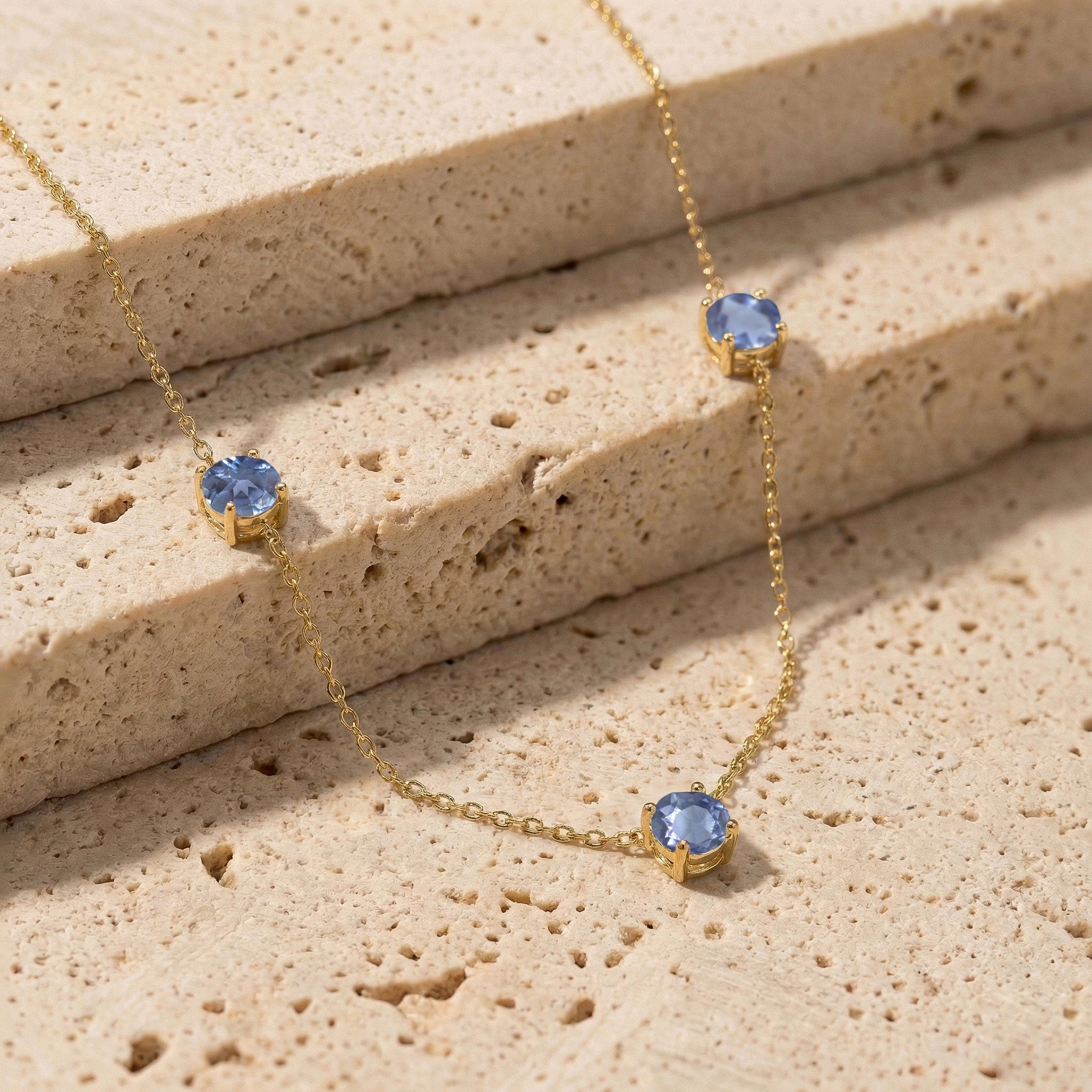 Fine jewelry Alexandrite necklace with classic three stone station design.
