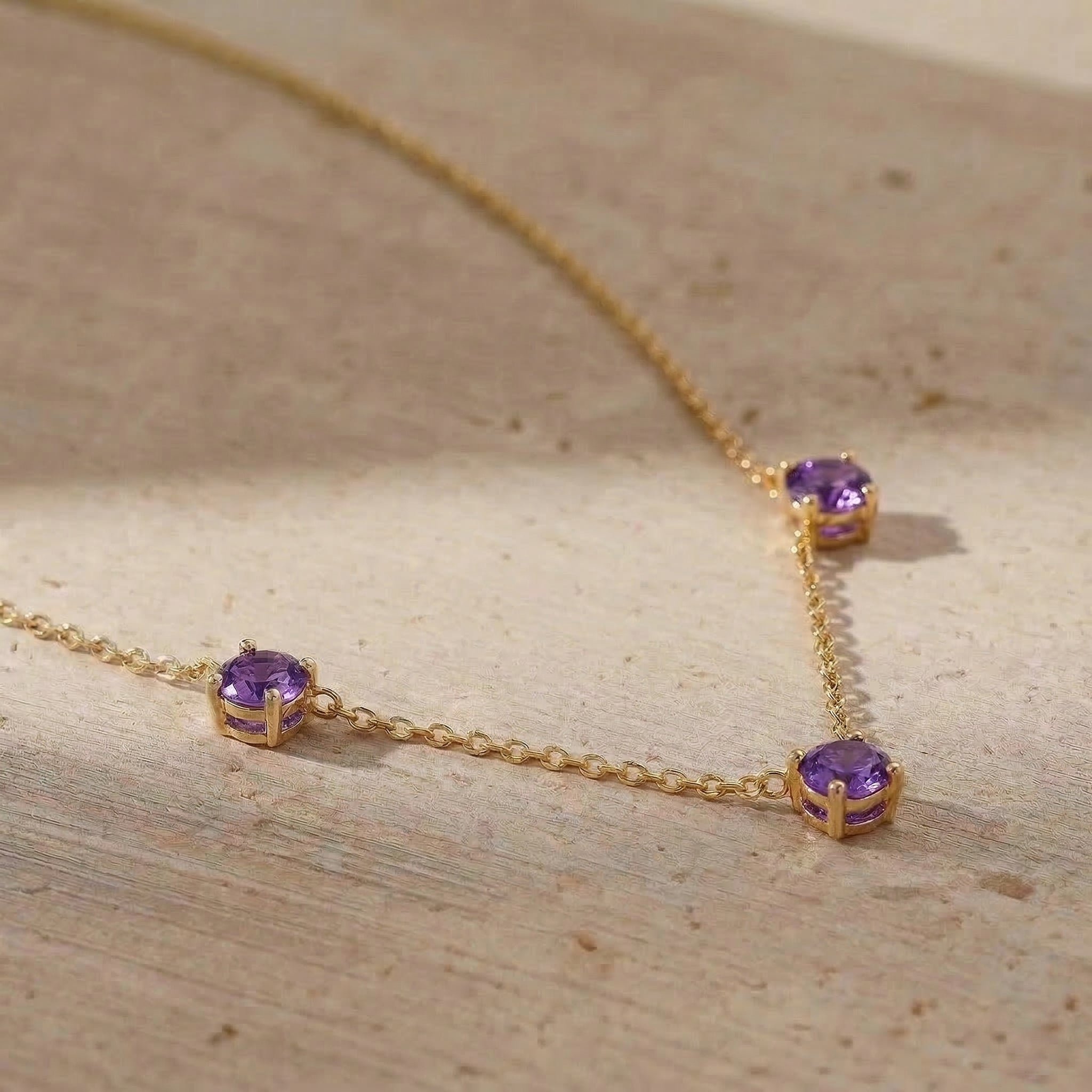 Elegant gemstone necklace featuring three round Amethyst stones for special occasions.
