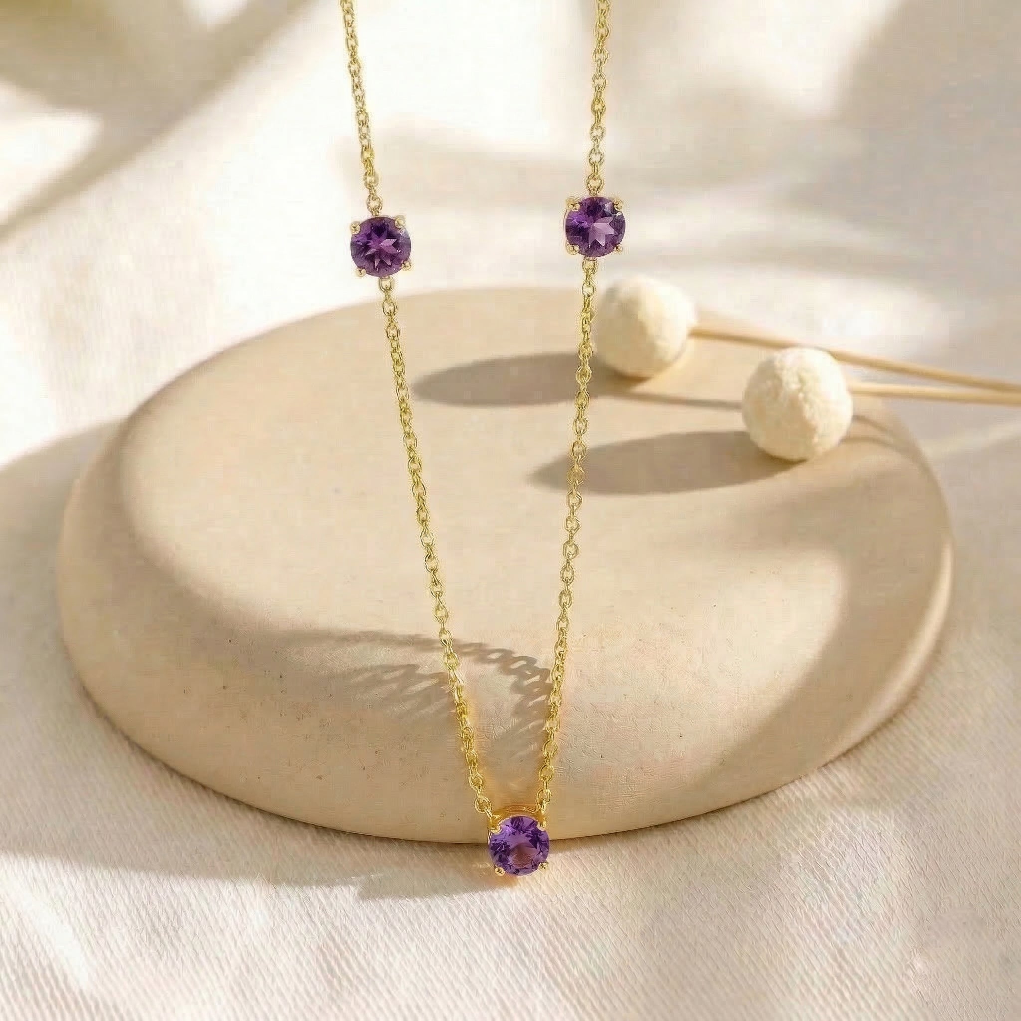 Layered Amethyst gemstone necklace featuring a delicate adjustable chain.
